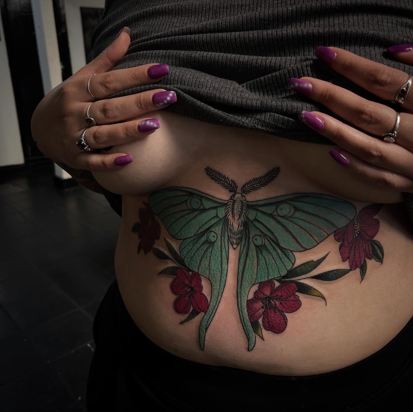 Luna moth and flowers realism tattoo on the torso by suzie