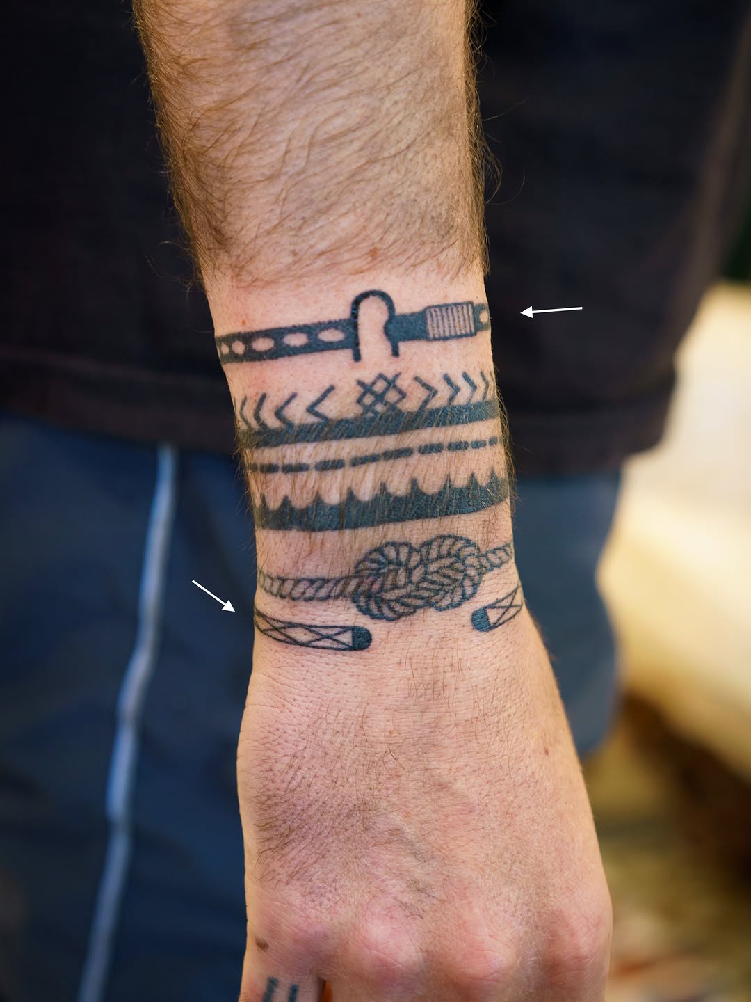 Bracelet with knot and geometric patterns tribal tattoo on the forearm by 思Stacy