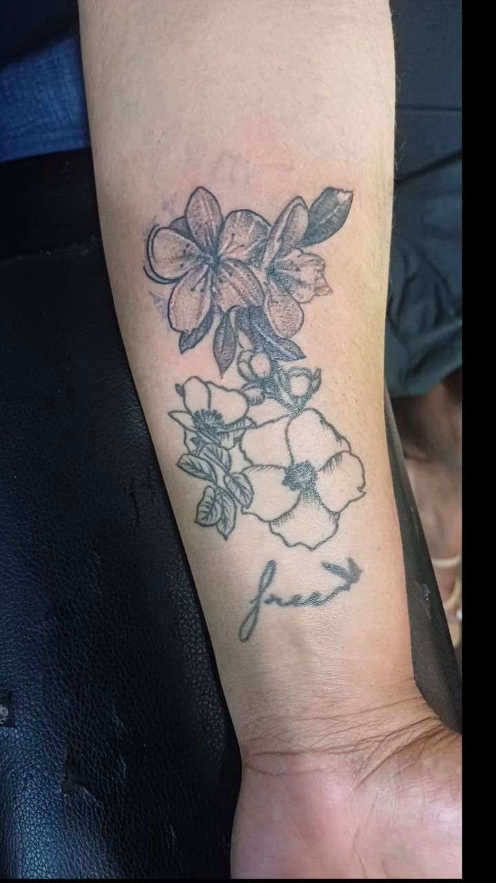 Floral design with anchor and script fine line tattoo on the forearm by Miami Beach Tattoo Artist