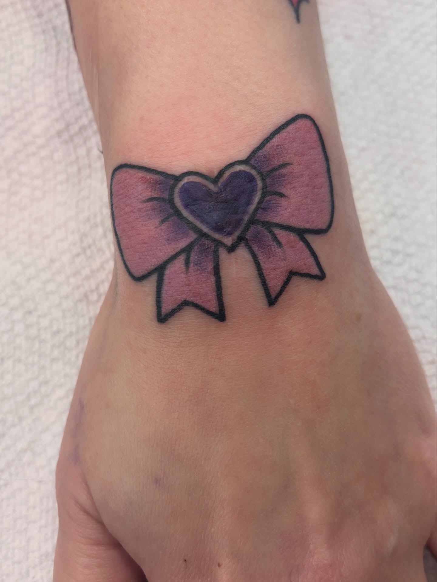 Bow with heart new school tattoo by Megan