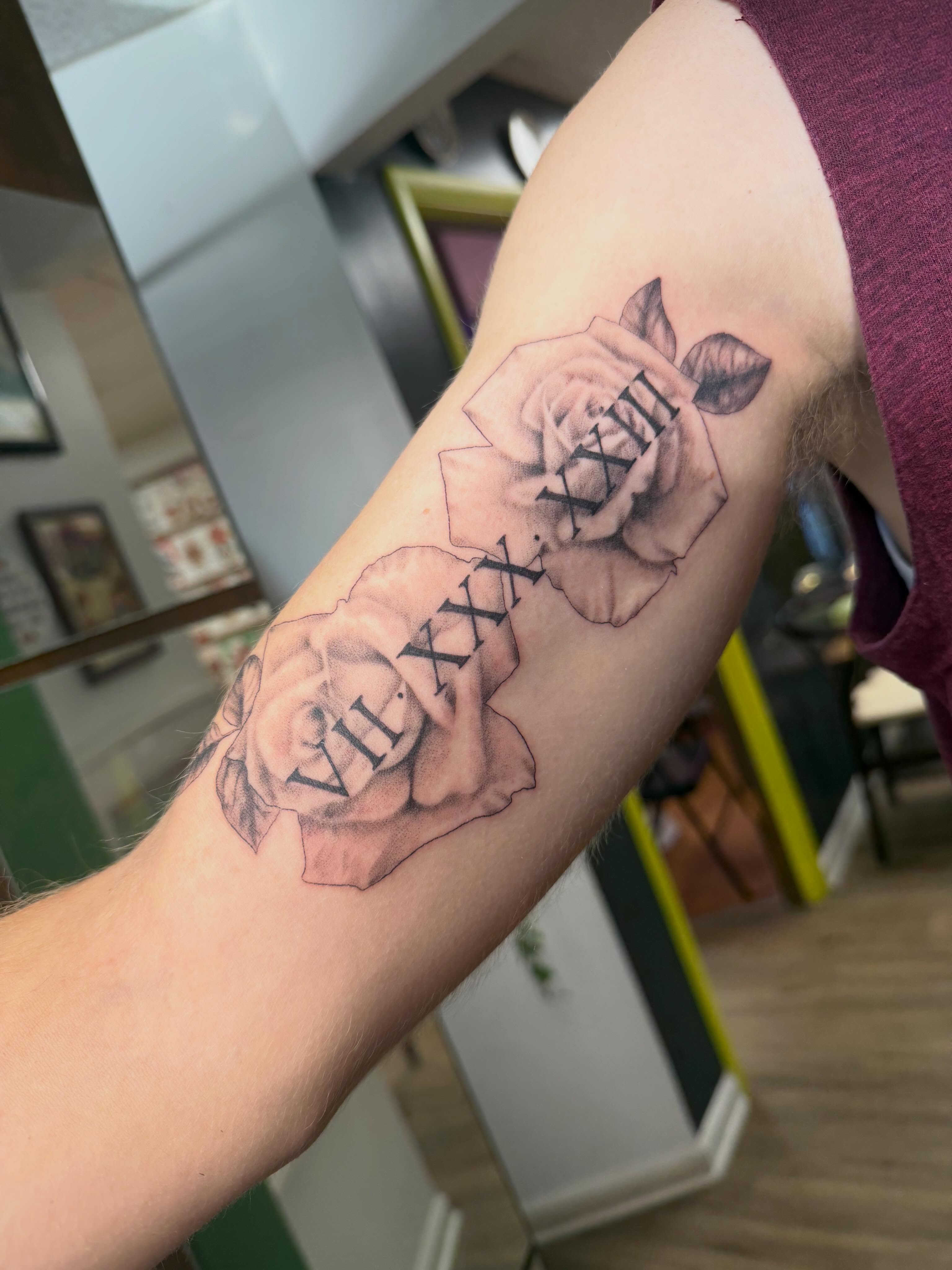 Roses and Roman numerals black and grey tattoo on the forearm by Rebecca (Becca) Ray