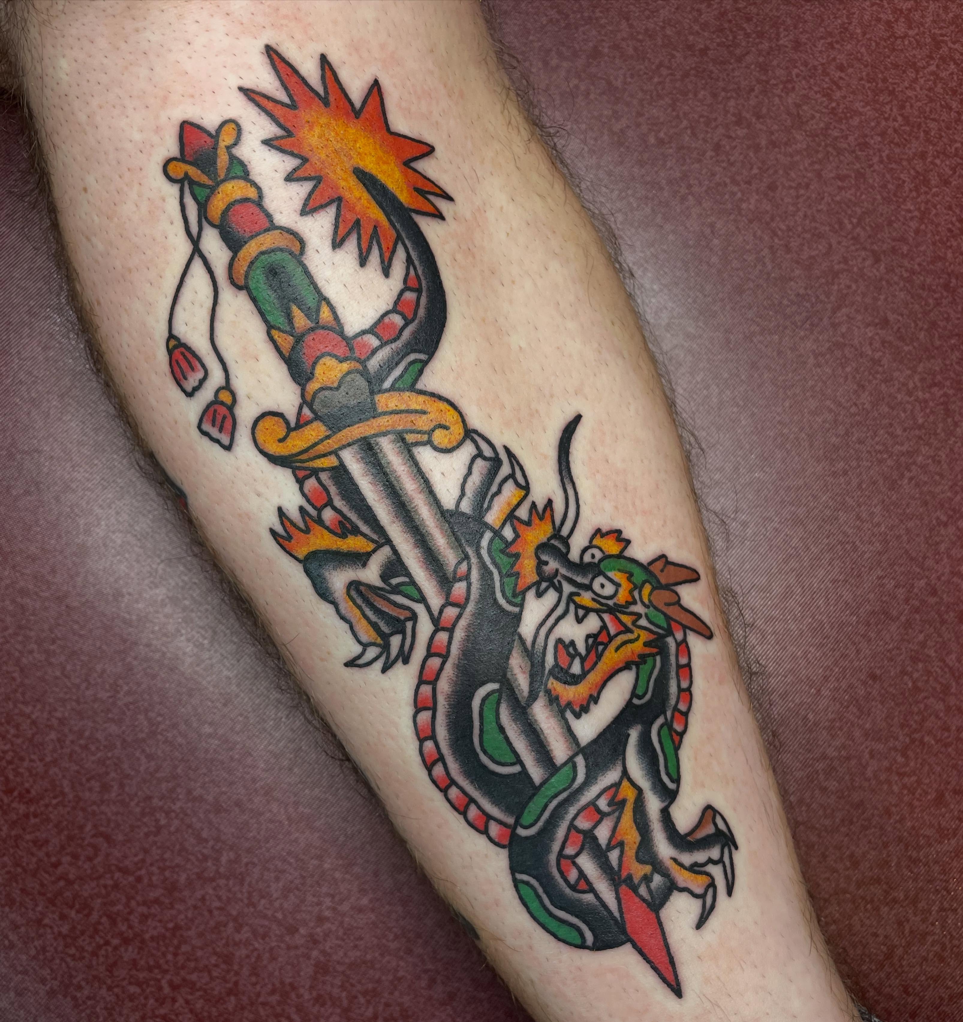 Dragon and sword American traditional tattoo on the forearm by Mitchell Willard