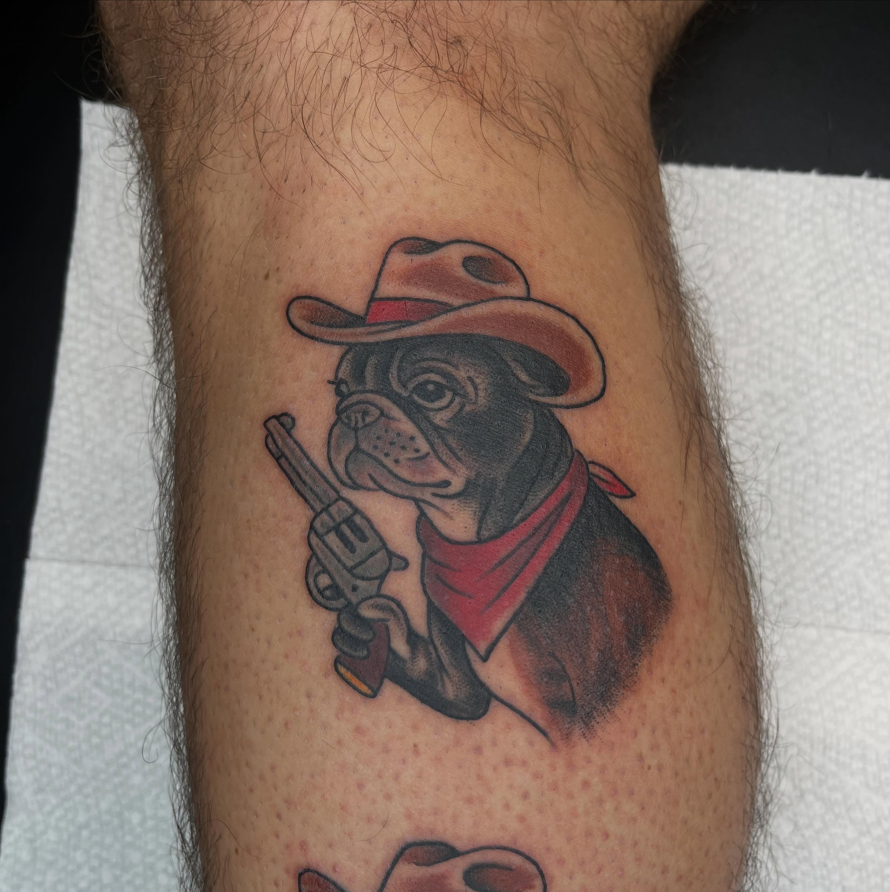 Bulldog cowboy realism tattoo on the forearm by Evan Voelker