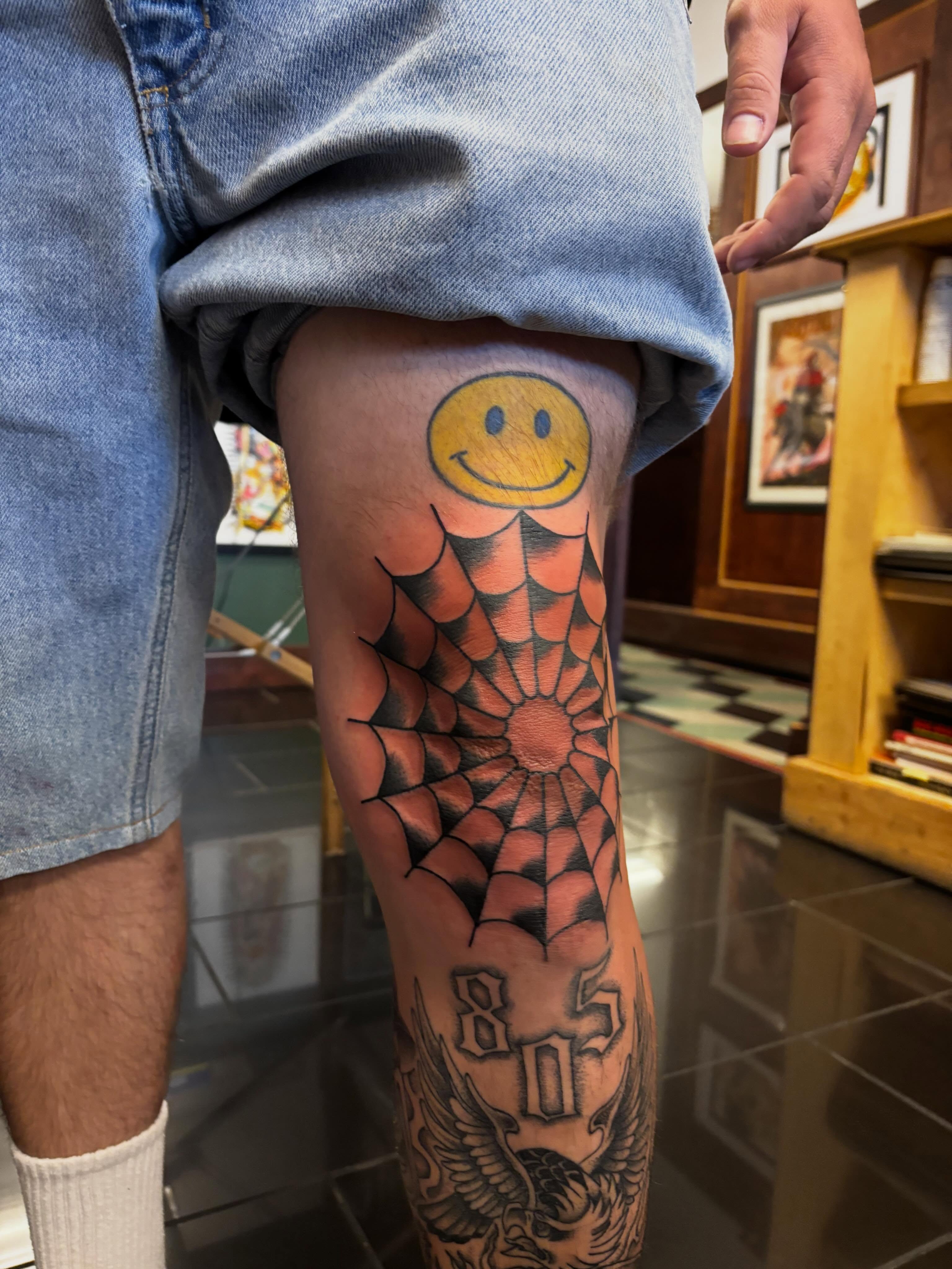 Smiley face American traditional tattoo on the thigh by Alyssa L'Heureux🕴🏼, Los Angeles, California