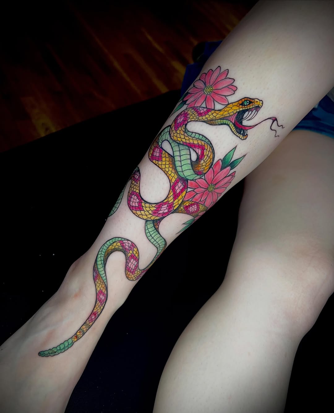 Snake and flowers new school tattoo on the forearm by jessica valentine
