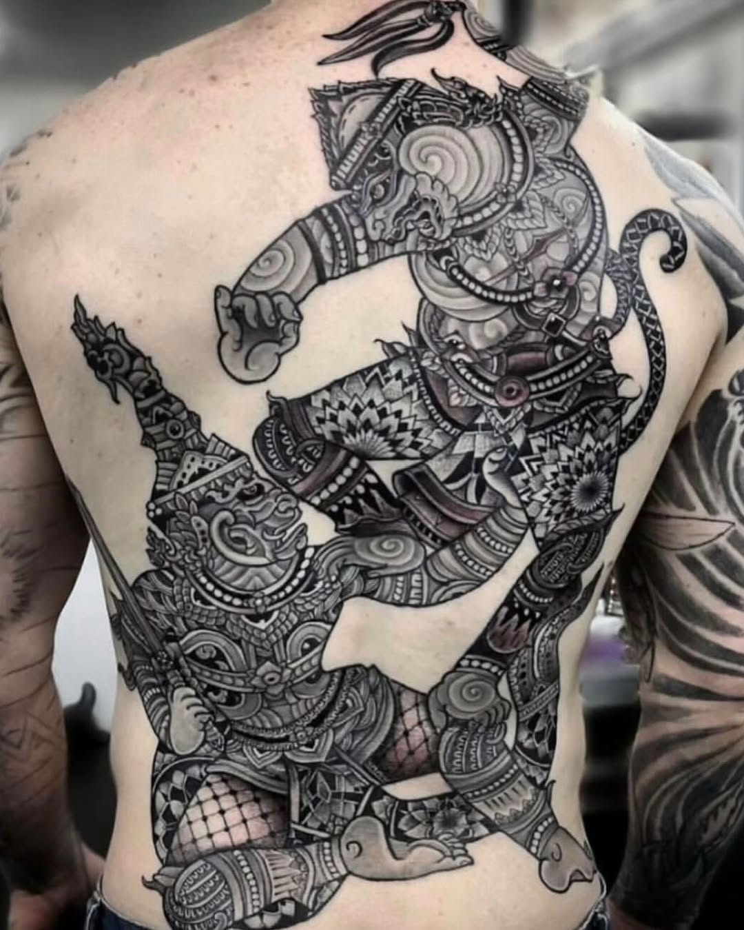 Two figures fighting Japanese tattoo on the back by miami tattoo artist