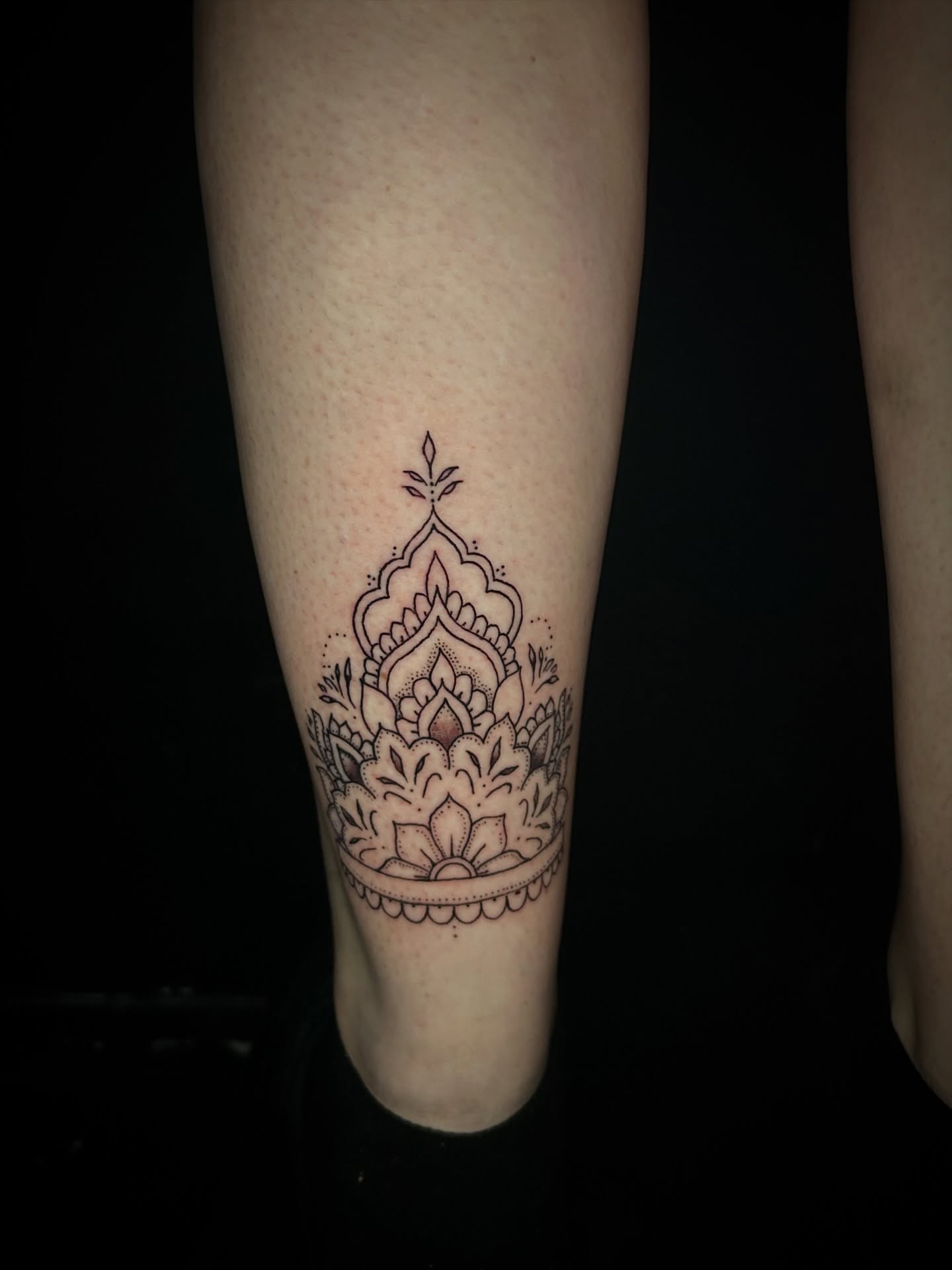 Lotus flower geometric tattoo on the calf by Fran
