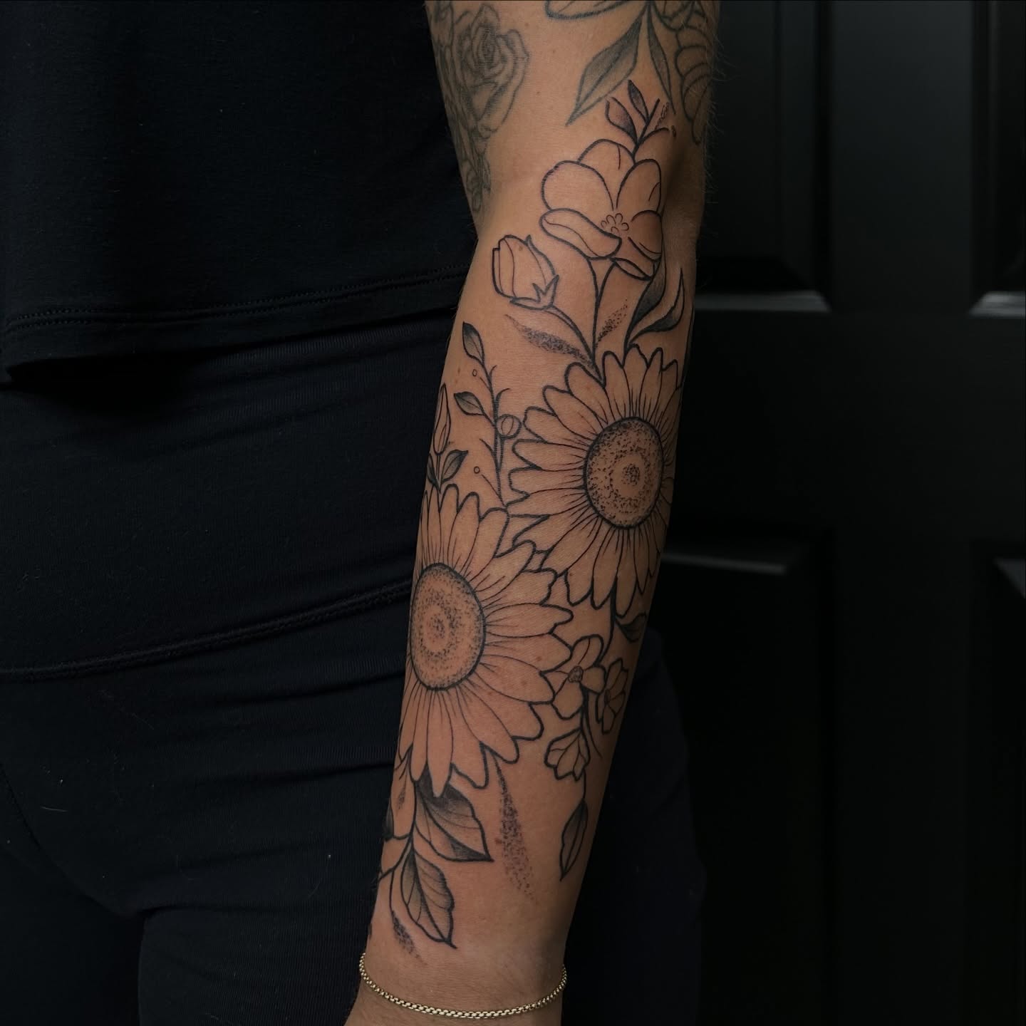 Sunflowers black and grey tattoo on the forearm by Tyler Renfrow