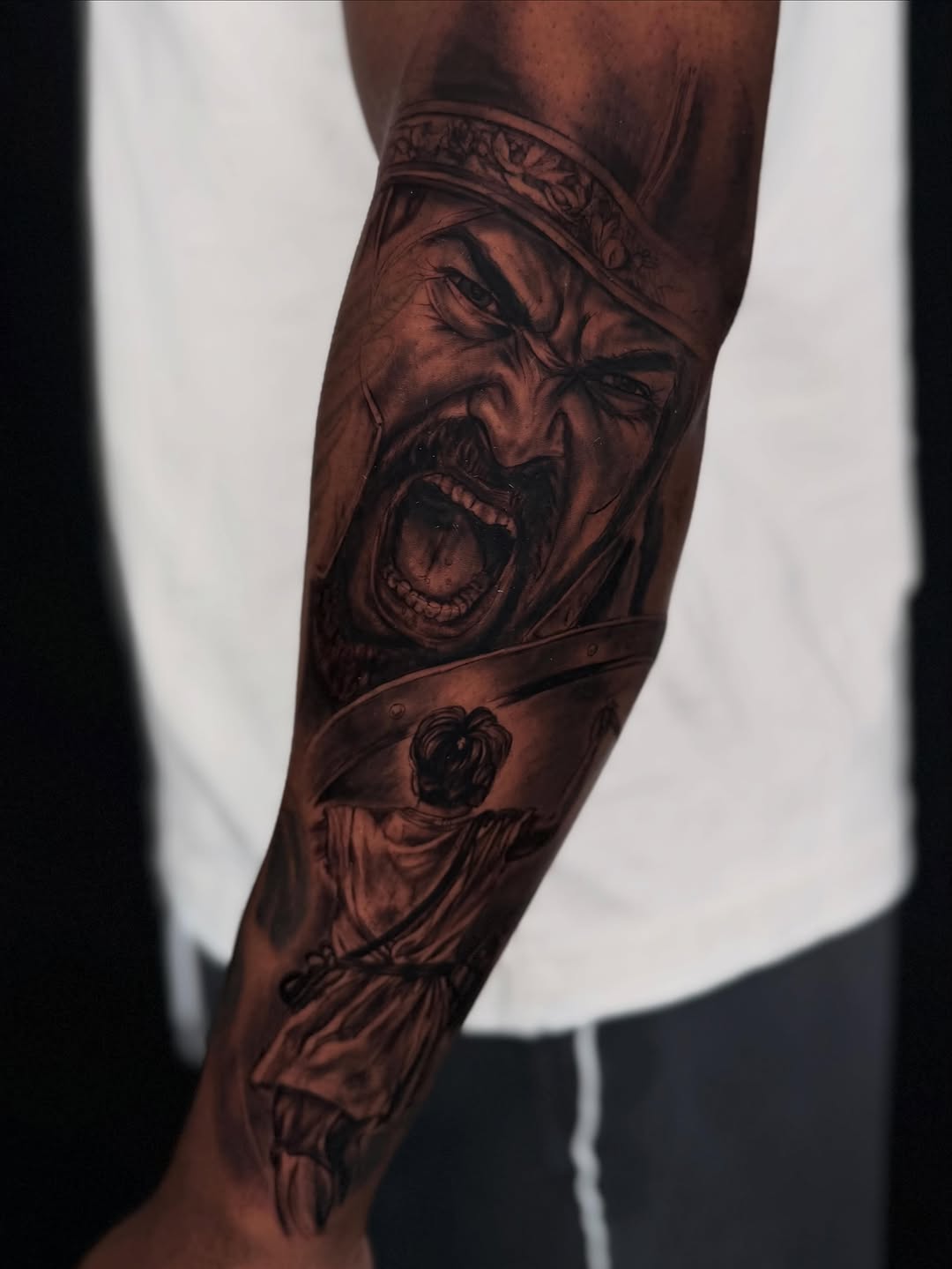 Warrior screaming with shield realism tattoo on the forearm by Idalia Pulido