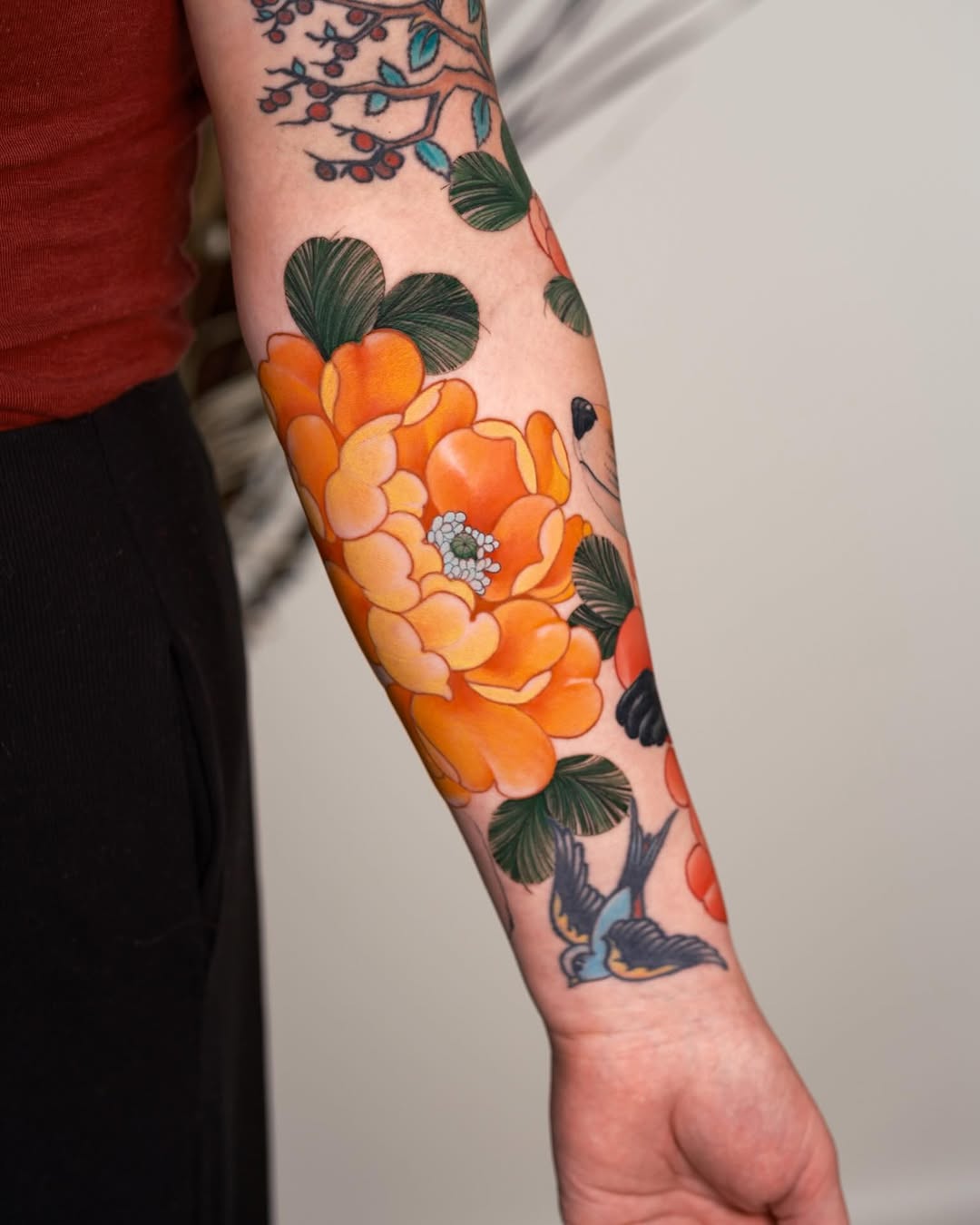 Peony and swallow neo-traditional tattoo on the forearm by Andres Acevedo, Denver, Colorado