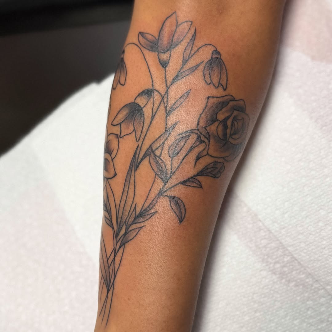 Flower bouquet black and grey tattoo on the forearm by Zac Tattooer