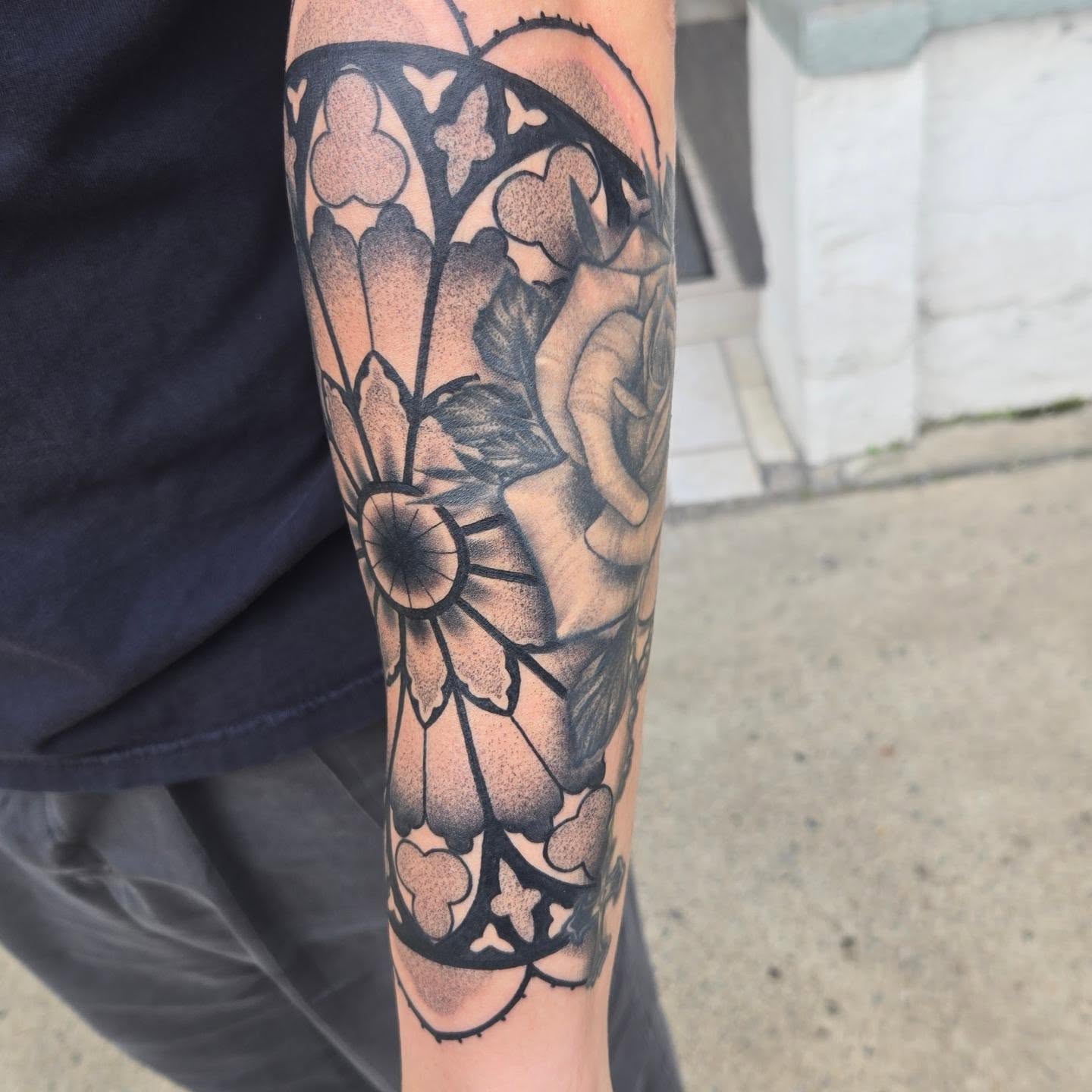 Flower and leaves black and grey tattoo on the forearm by Angel O'Connor Tattoos