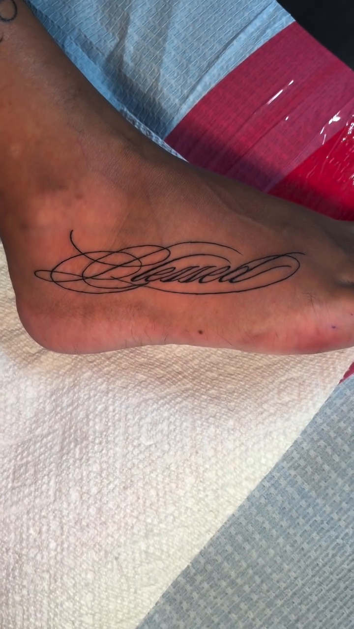Blessed script tattoo on foot tattoo on the foot by @getmoneetattz