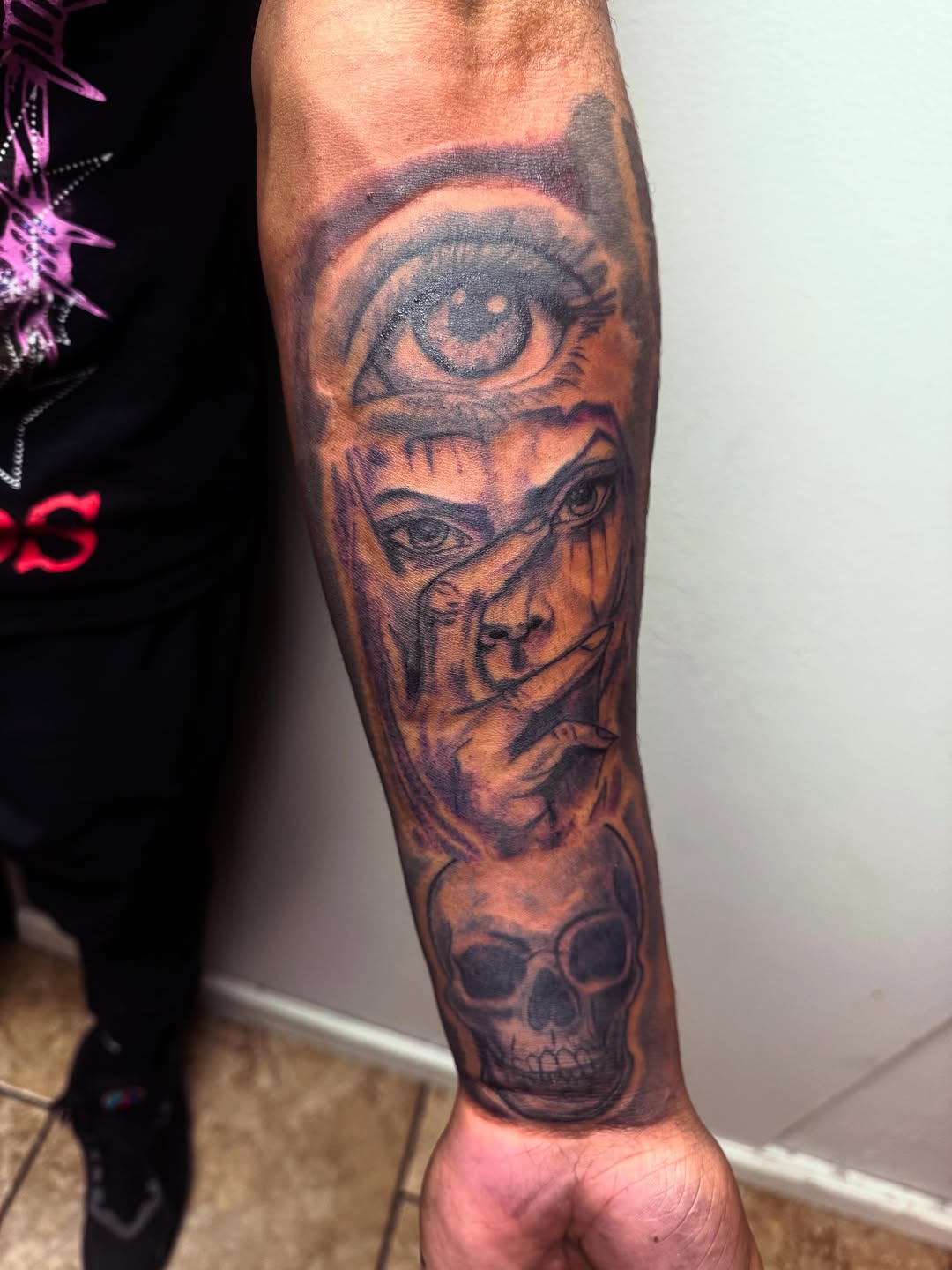 Eye, face, and skull realism tattoo on the forearm by Uncle Fade Tattoo Artist ✍🏾