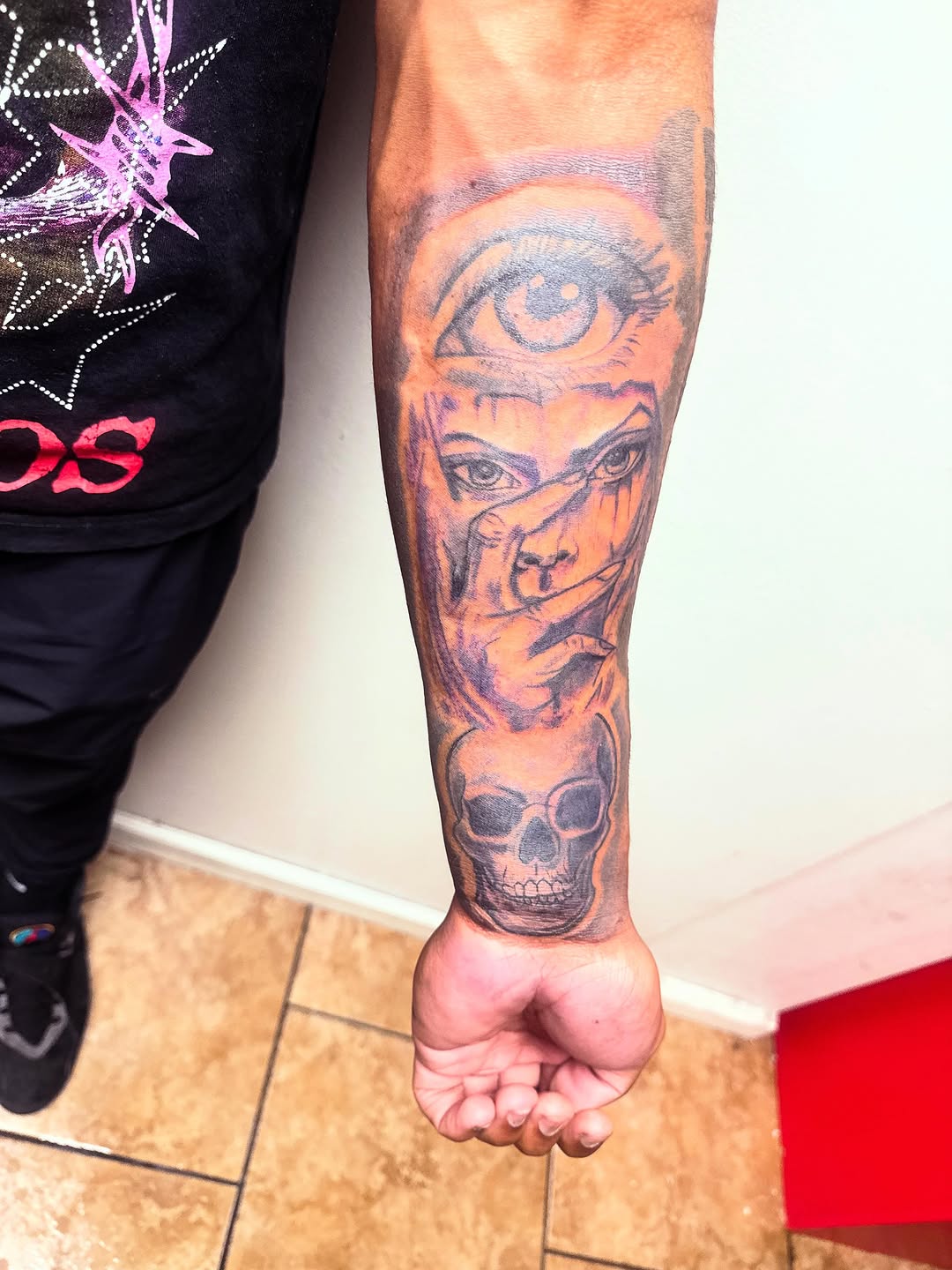 Eye, face, and skull realism tattoo on the forearm by Uncle Fade Tattoo Artist ✍🏾