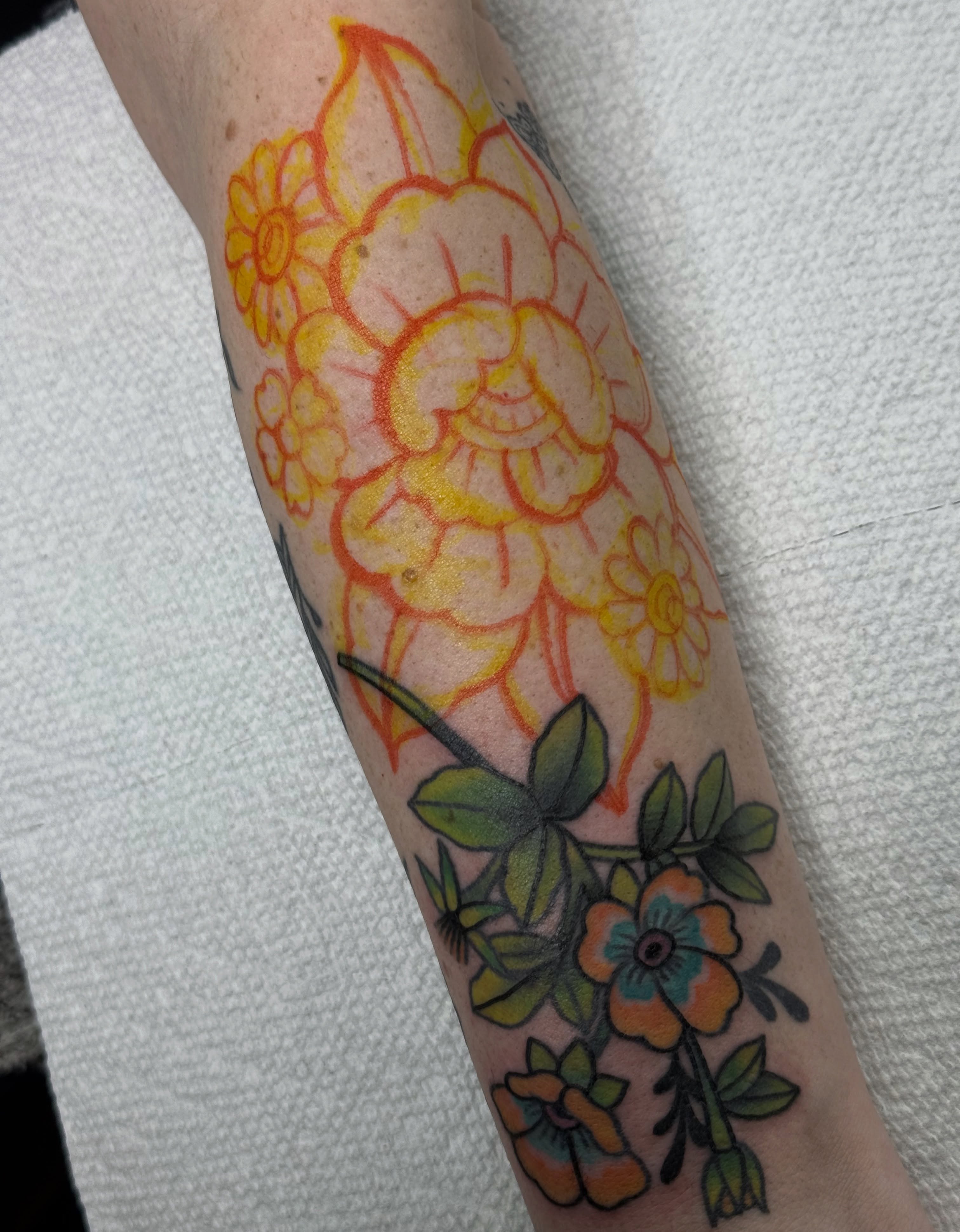 Floral bouquet American traditional tattoo on the forearm by Kara Mosqueda