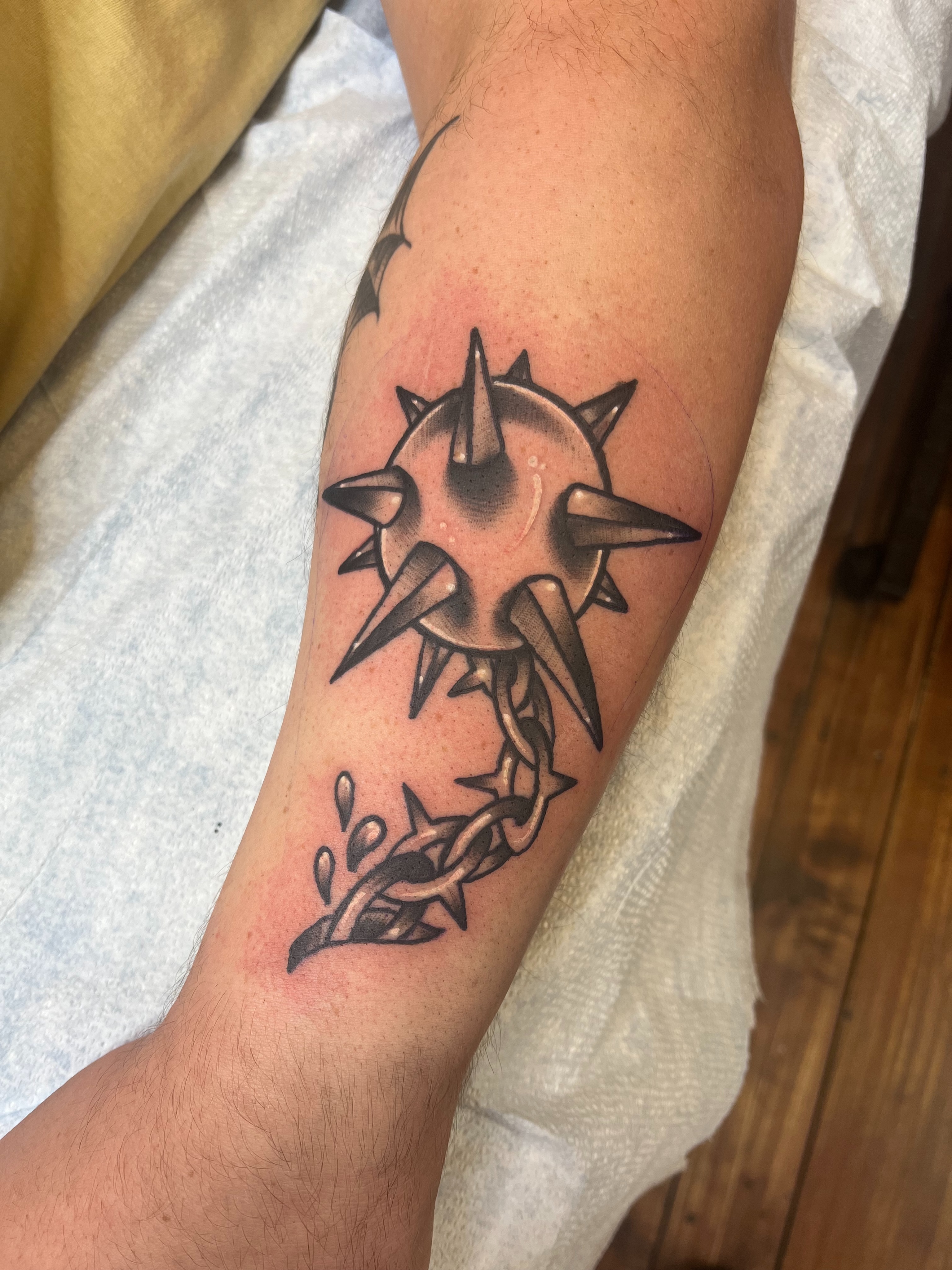 Spiked ball with barbed wire geometric tattoo on the forearm by Fizzy Jizzles, Worcester, England