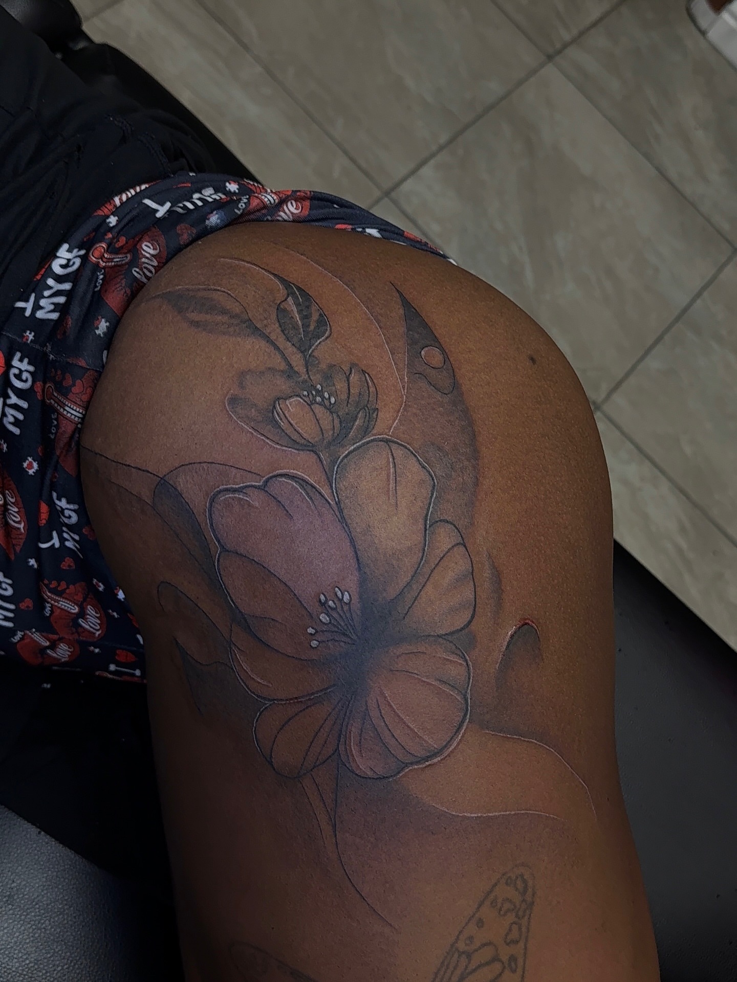 Flower black and grey tattoo on the thigh by XoticTherapy, Las Vegas, Nevada
