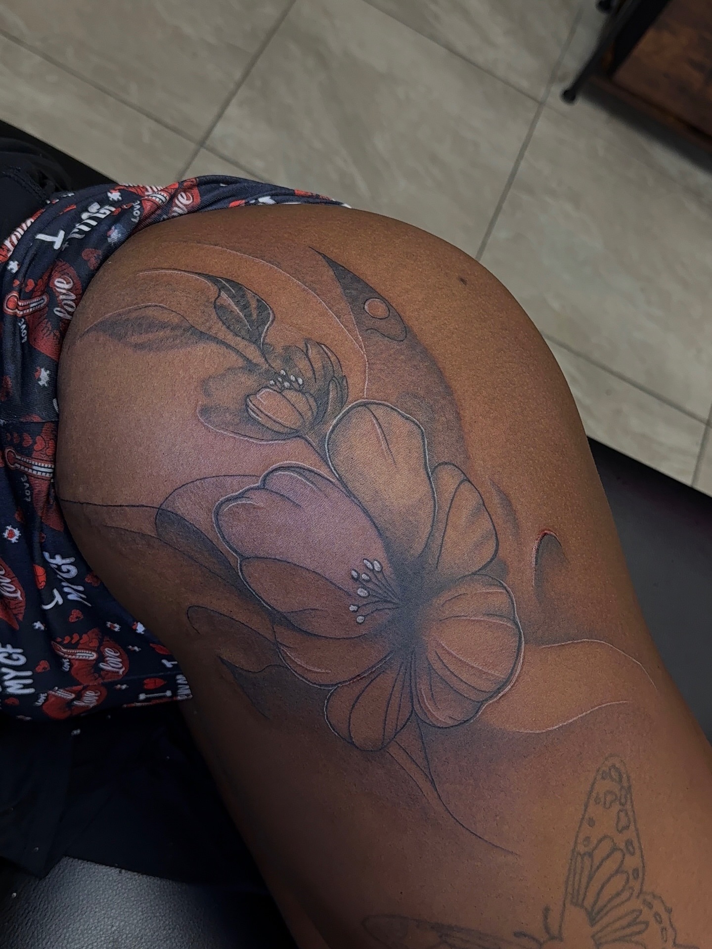 Flowers black and grey tattoo on the thigh by XoticTherapy, Las Vegas, Nevada