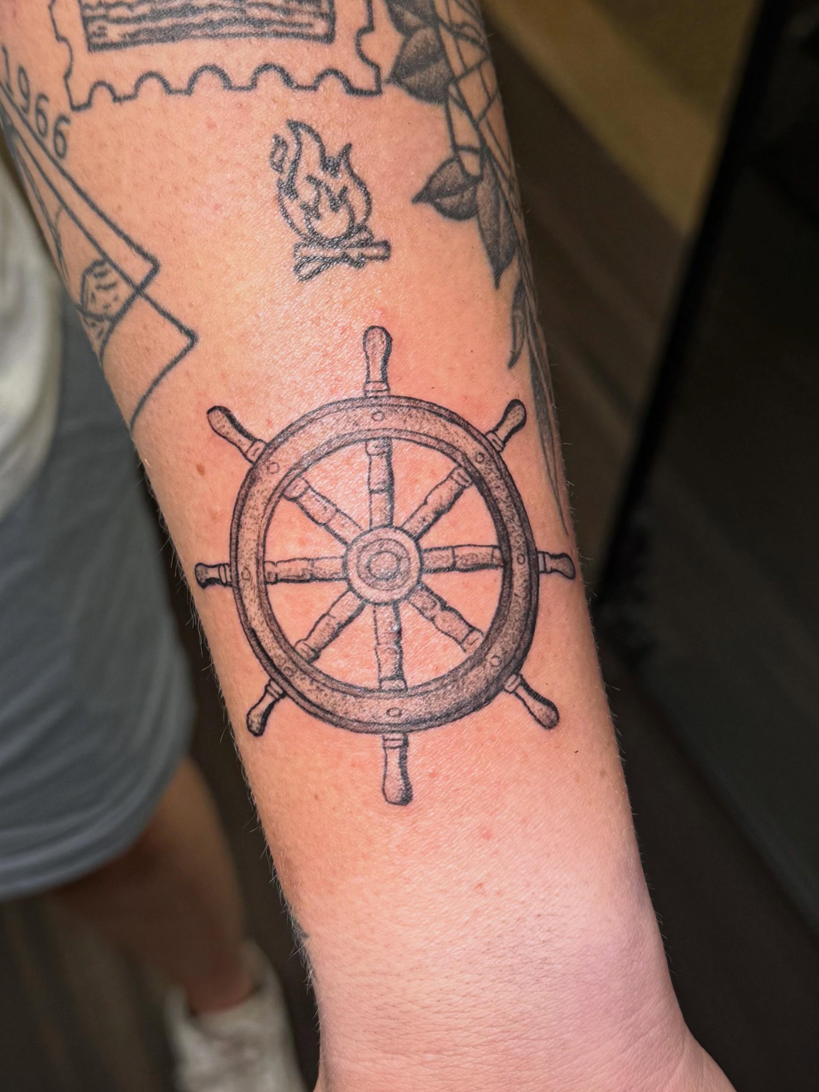 Ship's wheel black and grey tattoo on the forearm by βπ¬π―π’πΆ
