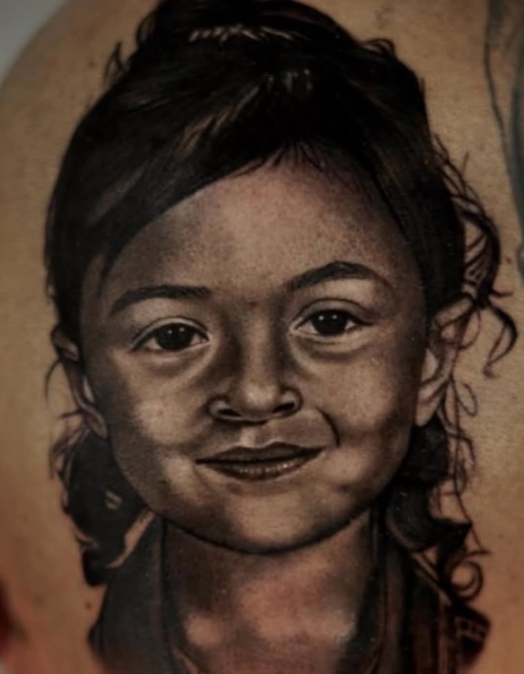 Portrait of a child realism tattoo on the shoulder by DREW ROMERO - Colorado Tattoo Artist, Pueblo, Colorado