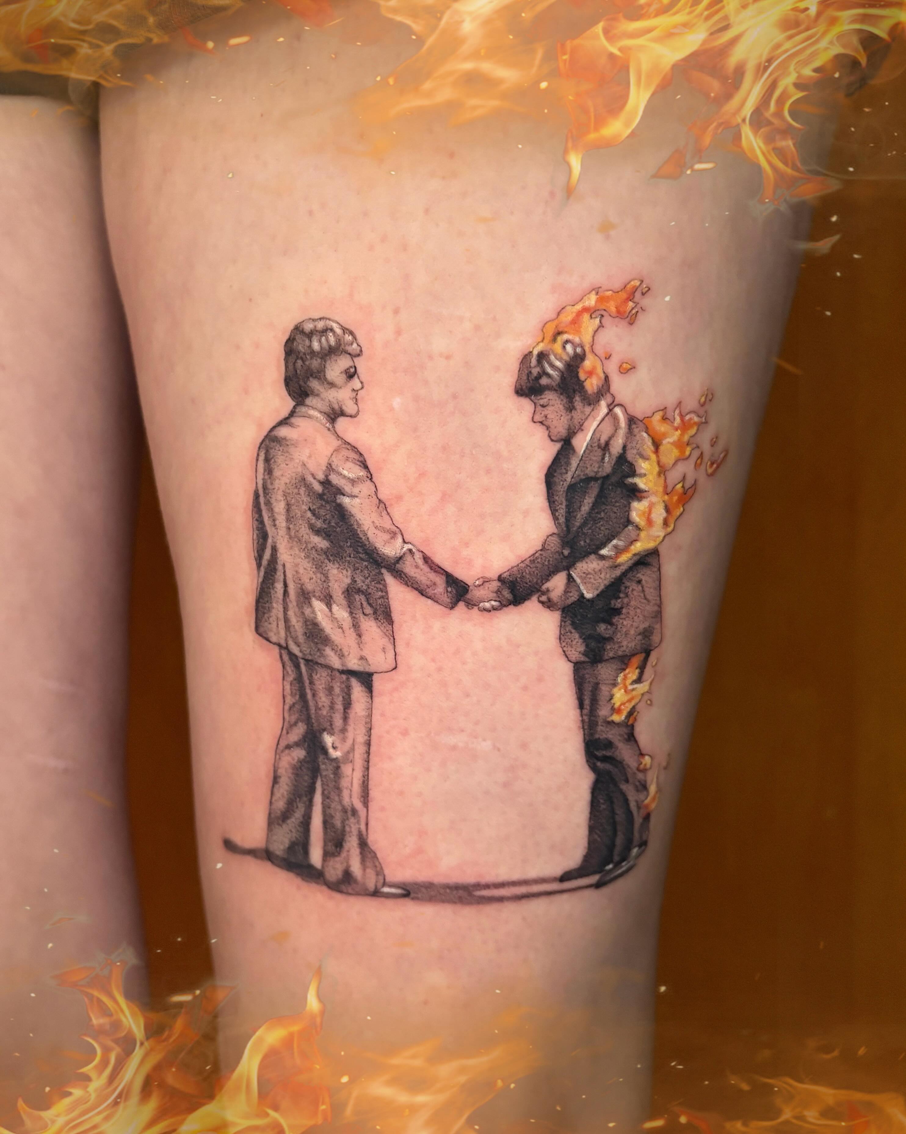 Handshake black and grey tattoo on the forearm by Autumn