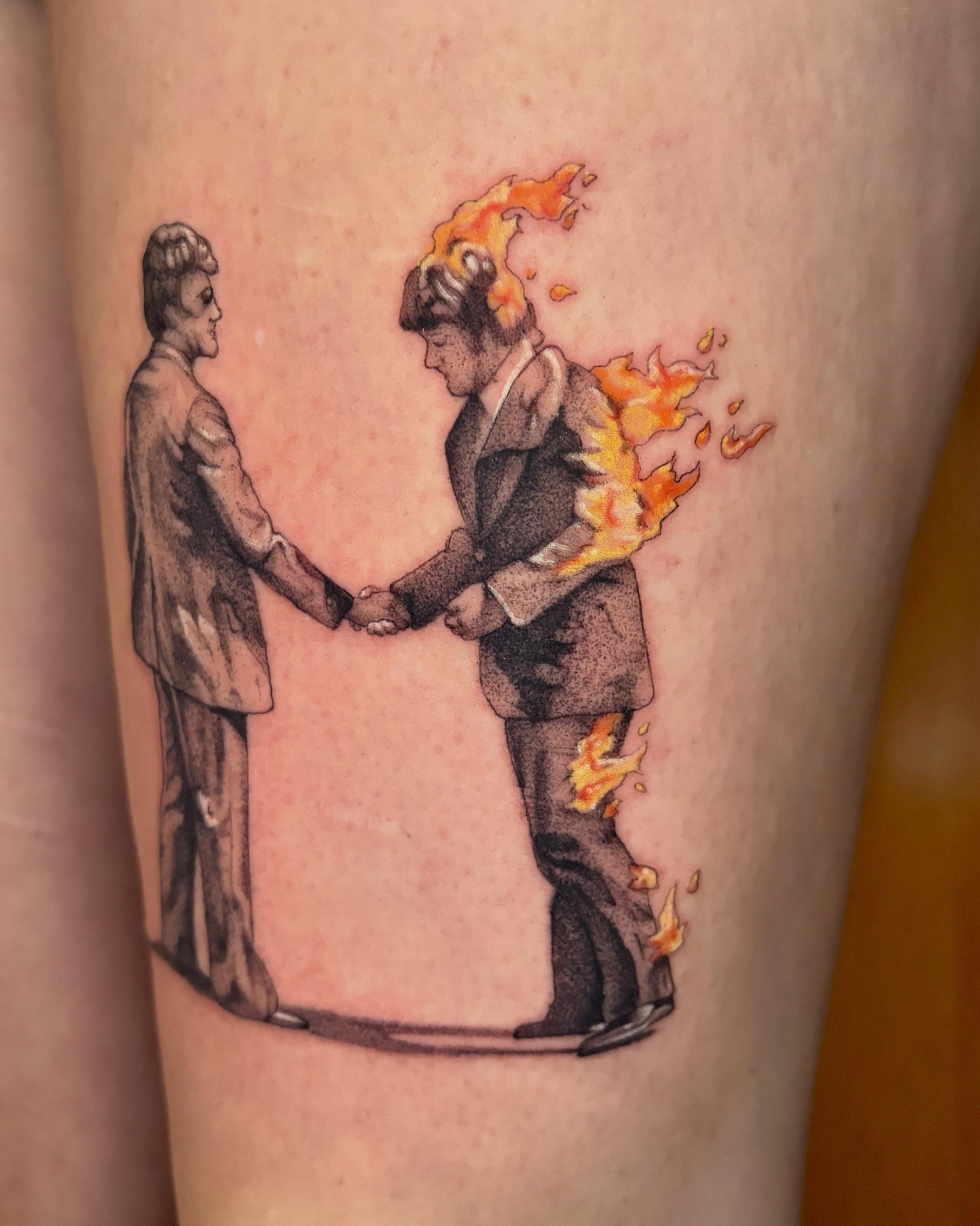 Handshake black and grey tattoo on the forearm by Autumn
