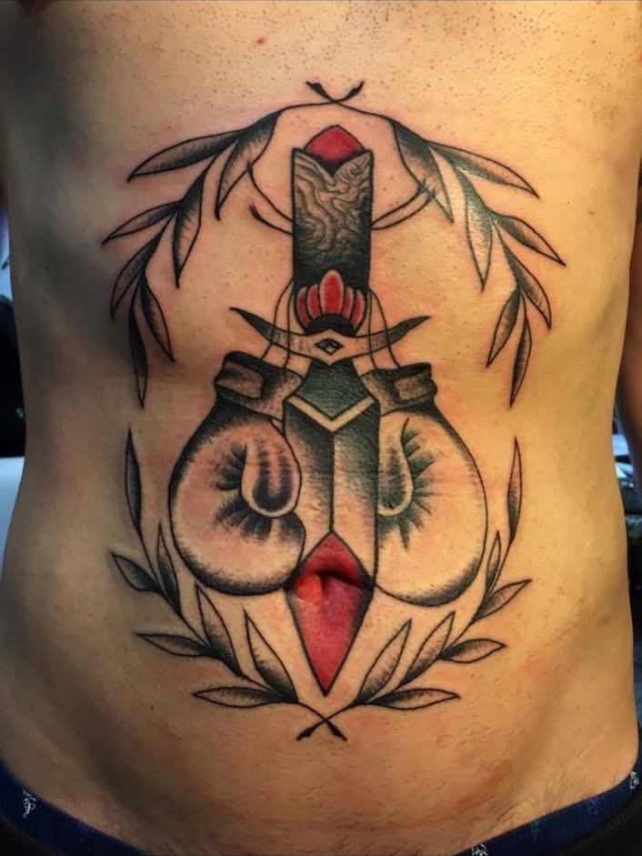 Boxing gloves and sword American traditional tattoo on the ribs by Alessandro Pennella