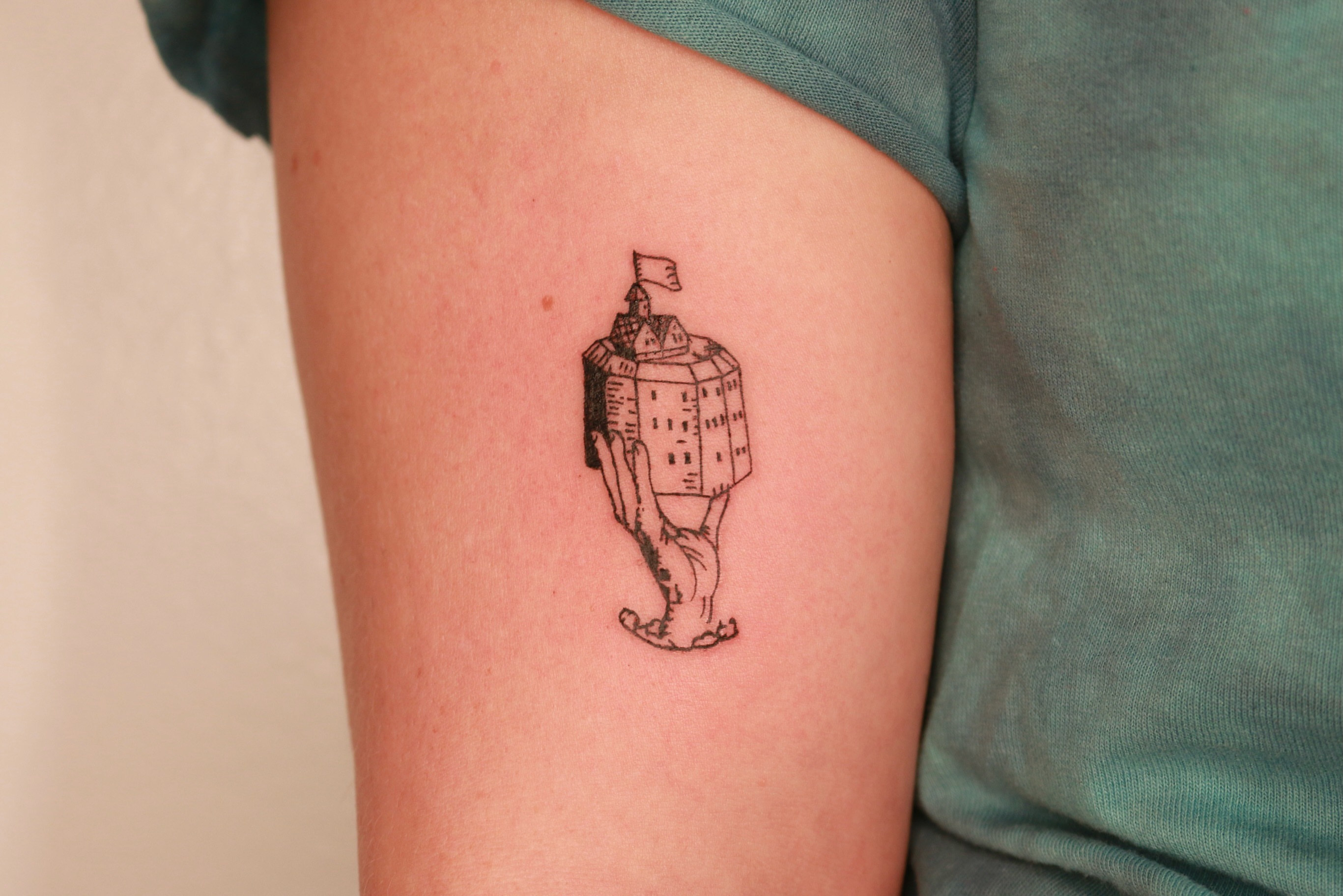 Castle on legs geometric tattoo on the thigh by Mike
