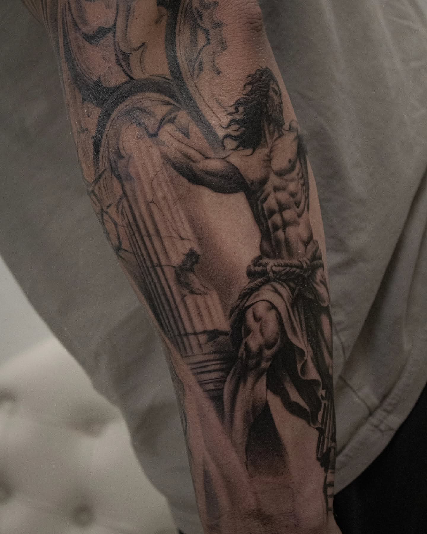 Statue of jesus realism tattoo on the forearm by Erik Bonilla