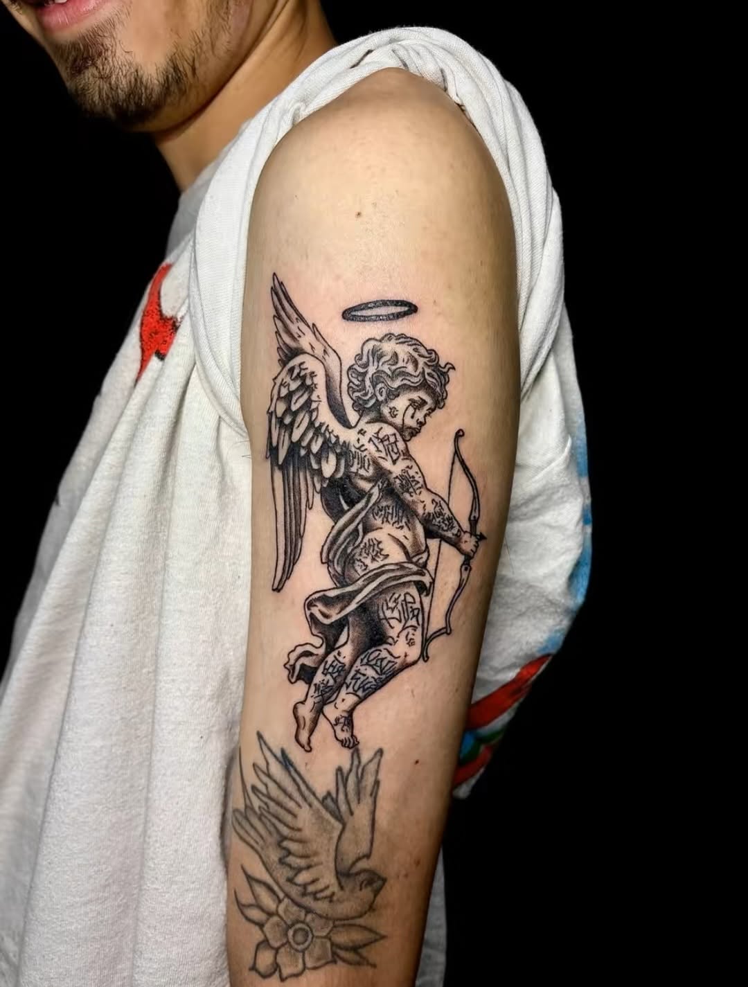 Cherub with bow and arrow realism tattoo on the forearm by JT.tattoos