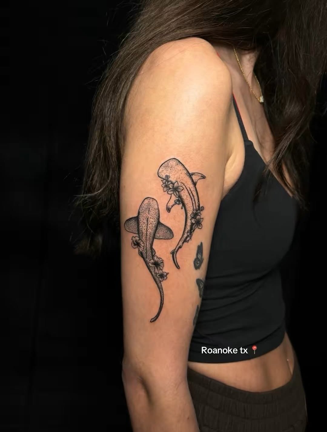 Two whale sharks with flowers fine line tattoo on the upper arm by JT.tattoos