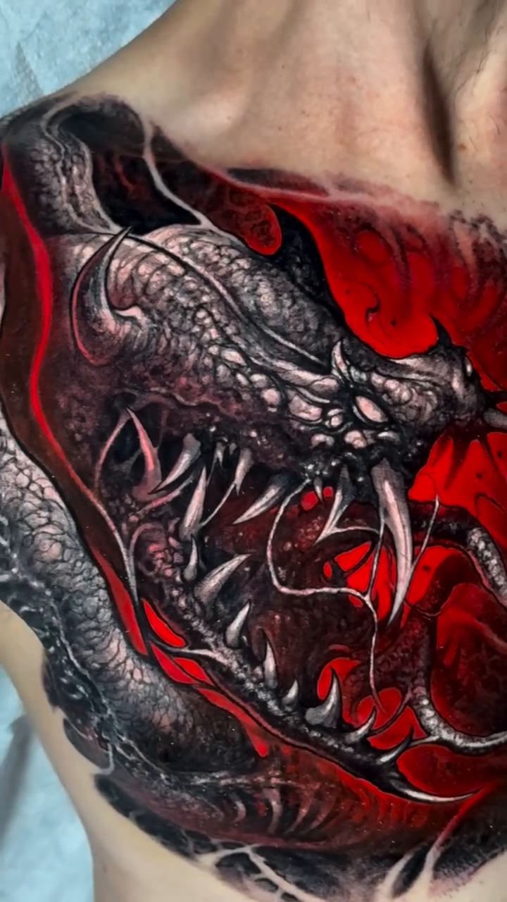 Dragon and skull chest piece realism tattoo on the chest by Brandon Herrera