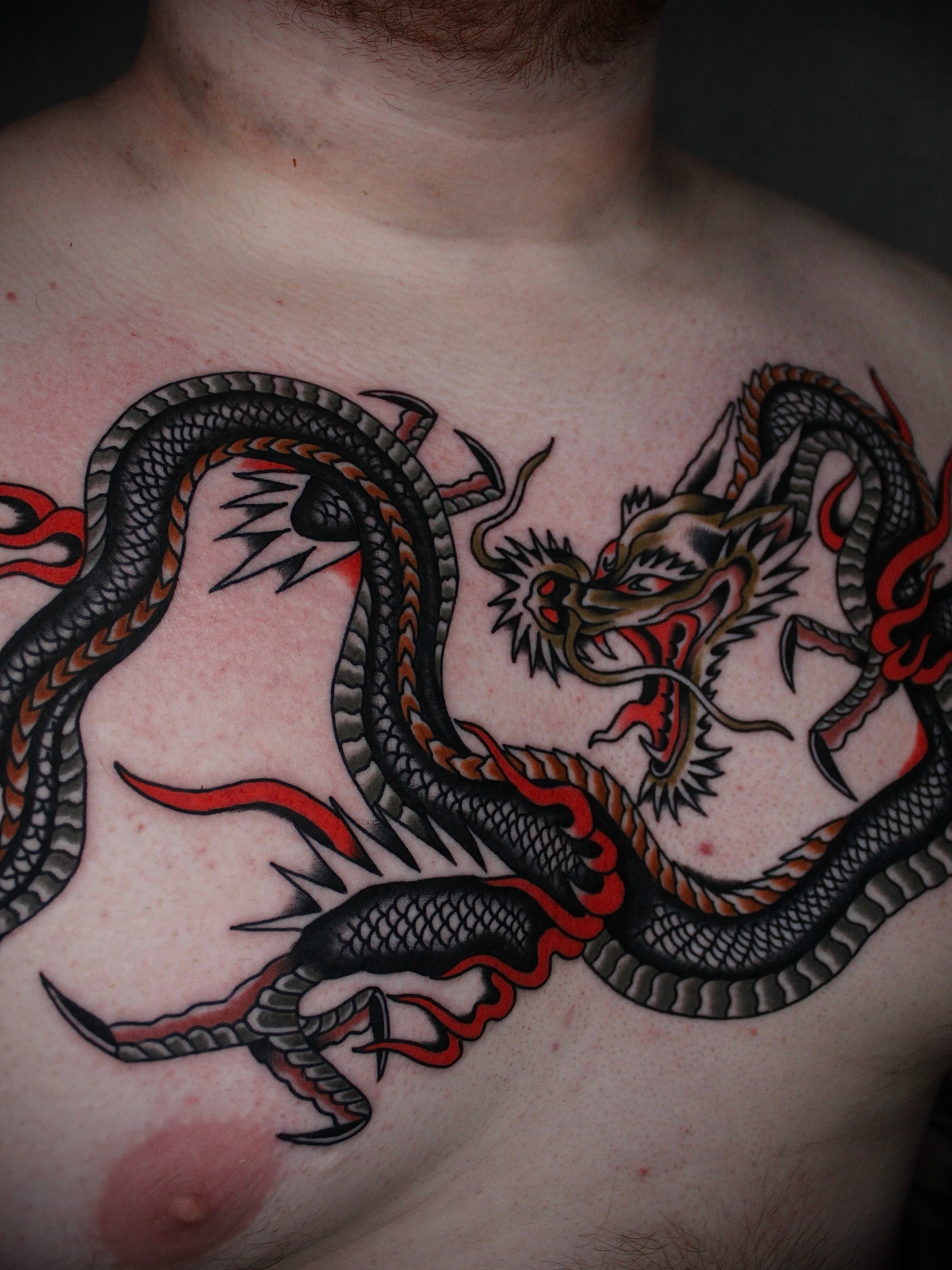Dragon American traditional tattoo on the chest by Dustin Stemen, Charlotte, North Carolina