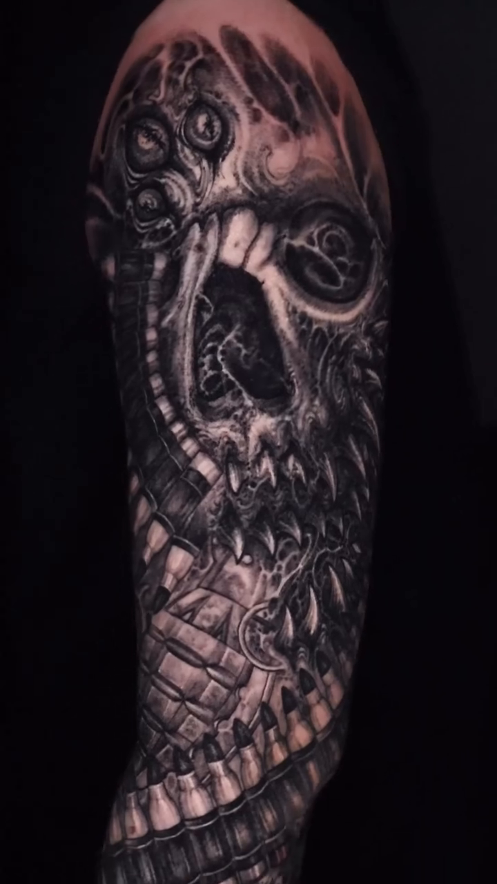 Biomechanical skull sleeve biomech tattoo on the upper arm by Dark tattoo