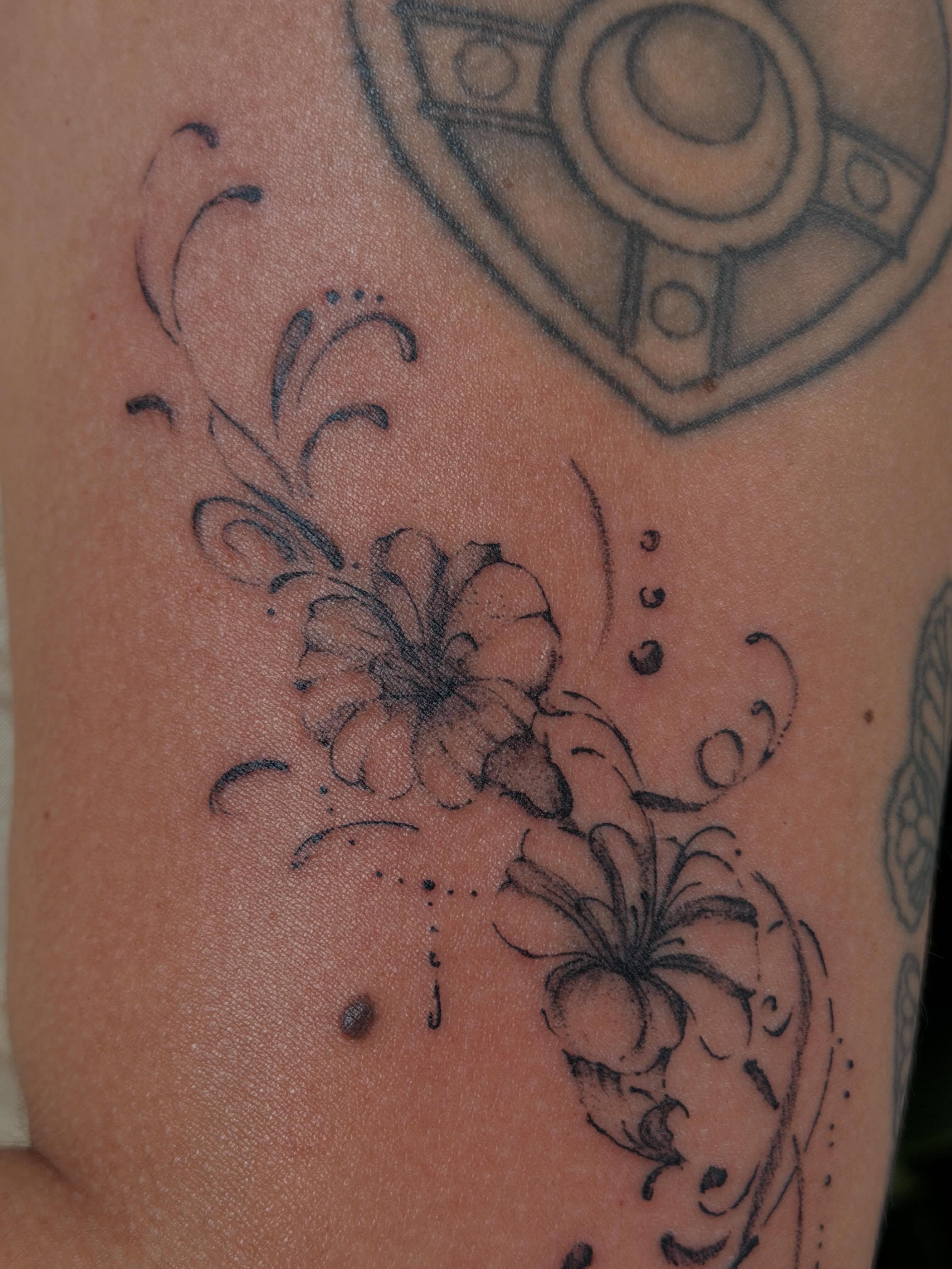 Floral design black and grey tattoo on the upper arm by Babymaxy Inks Llc