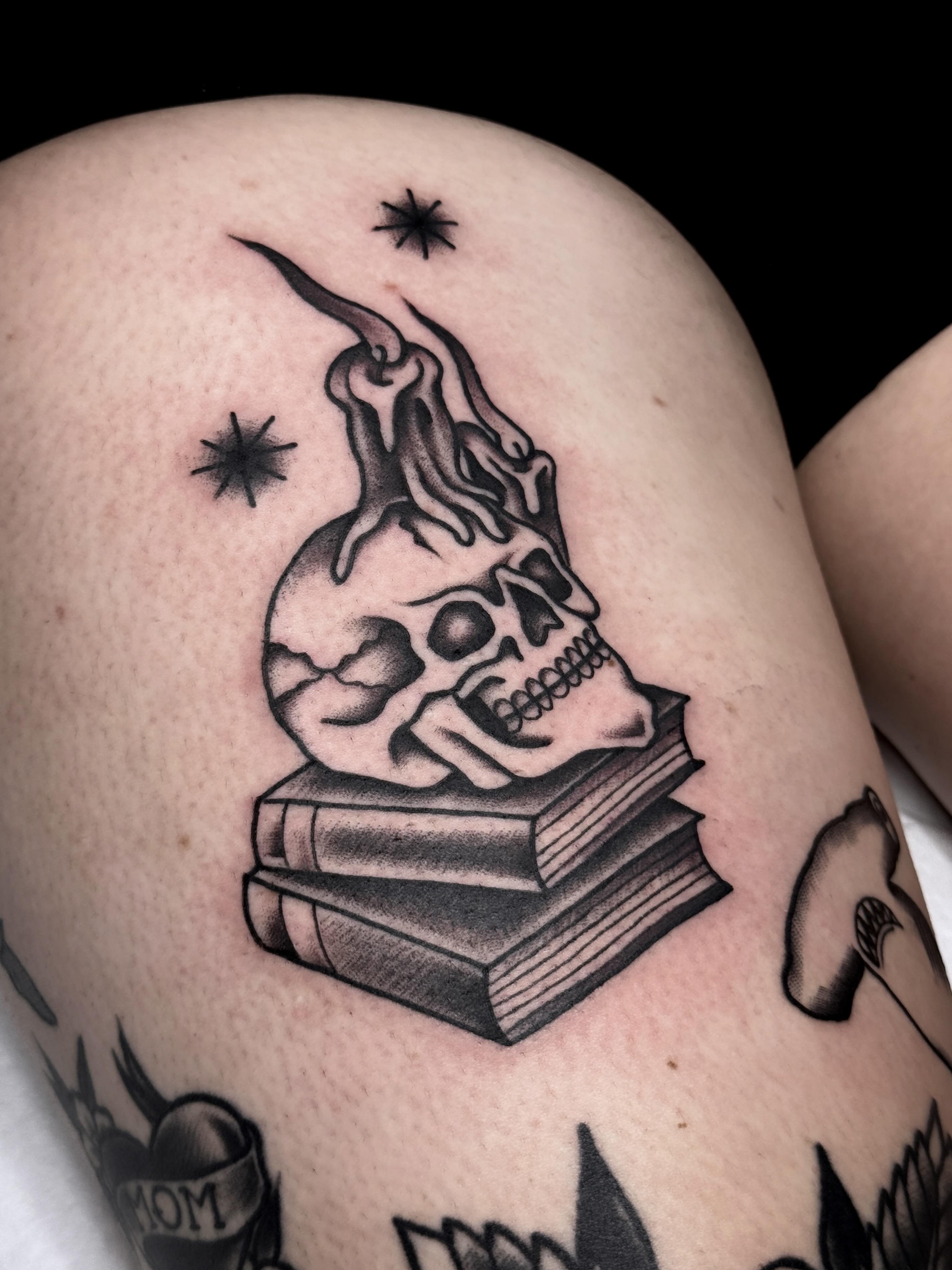 Skull and books black and grey tattoo on the thigh by Trav, Bayville, New Jersey