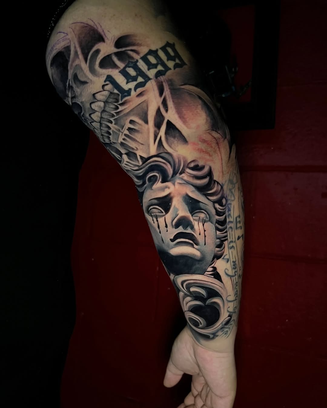 Statue with tears and numbers realism tattoo on the forearm by El Salvador Tattoo Artist