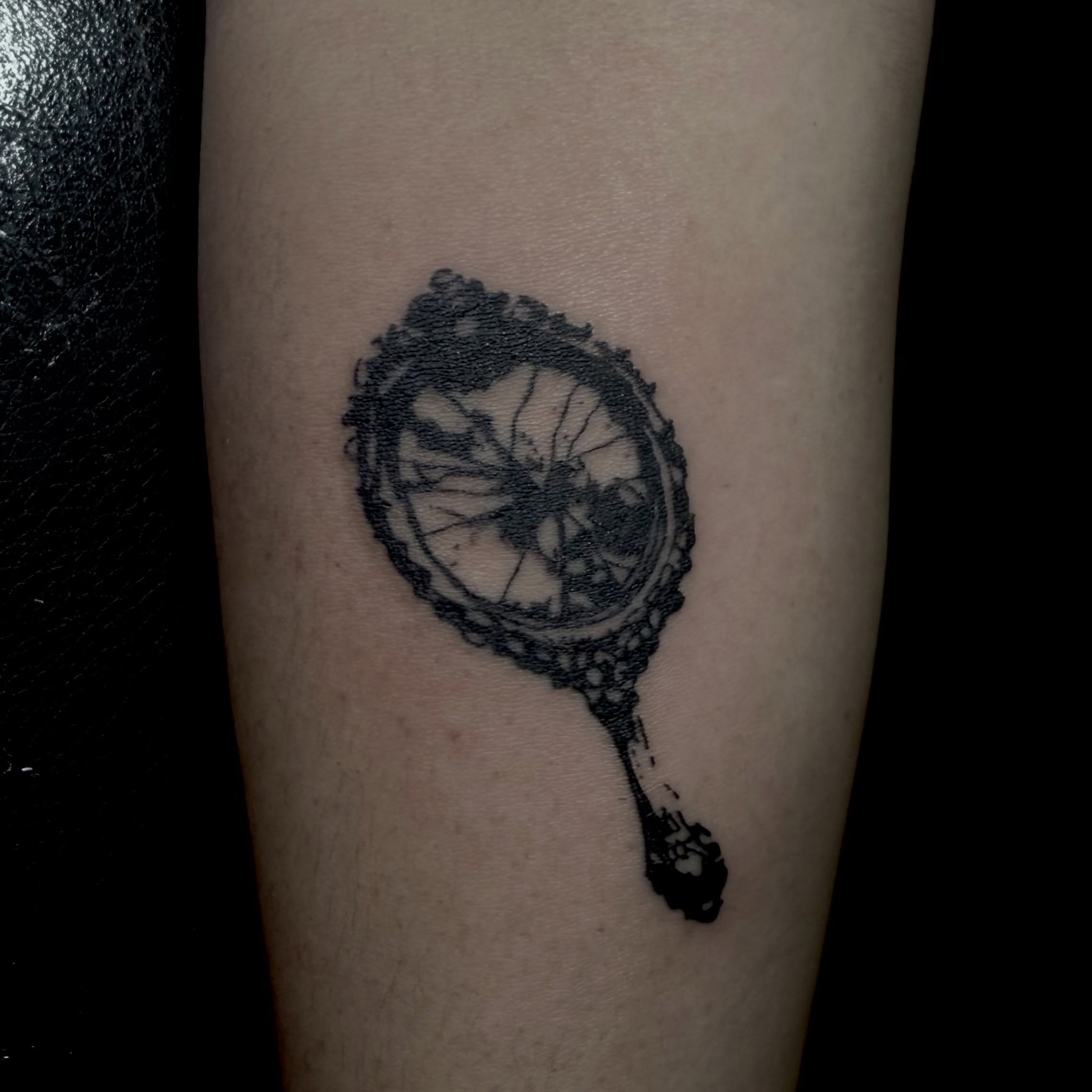 Bicycle wheel black and grey tattoo on the forearm by Jordan Sandoval