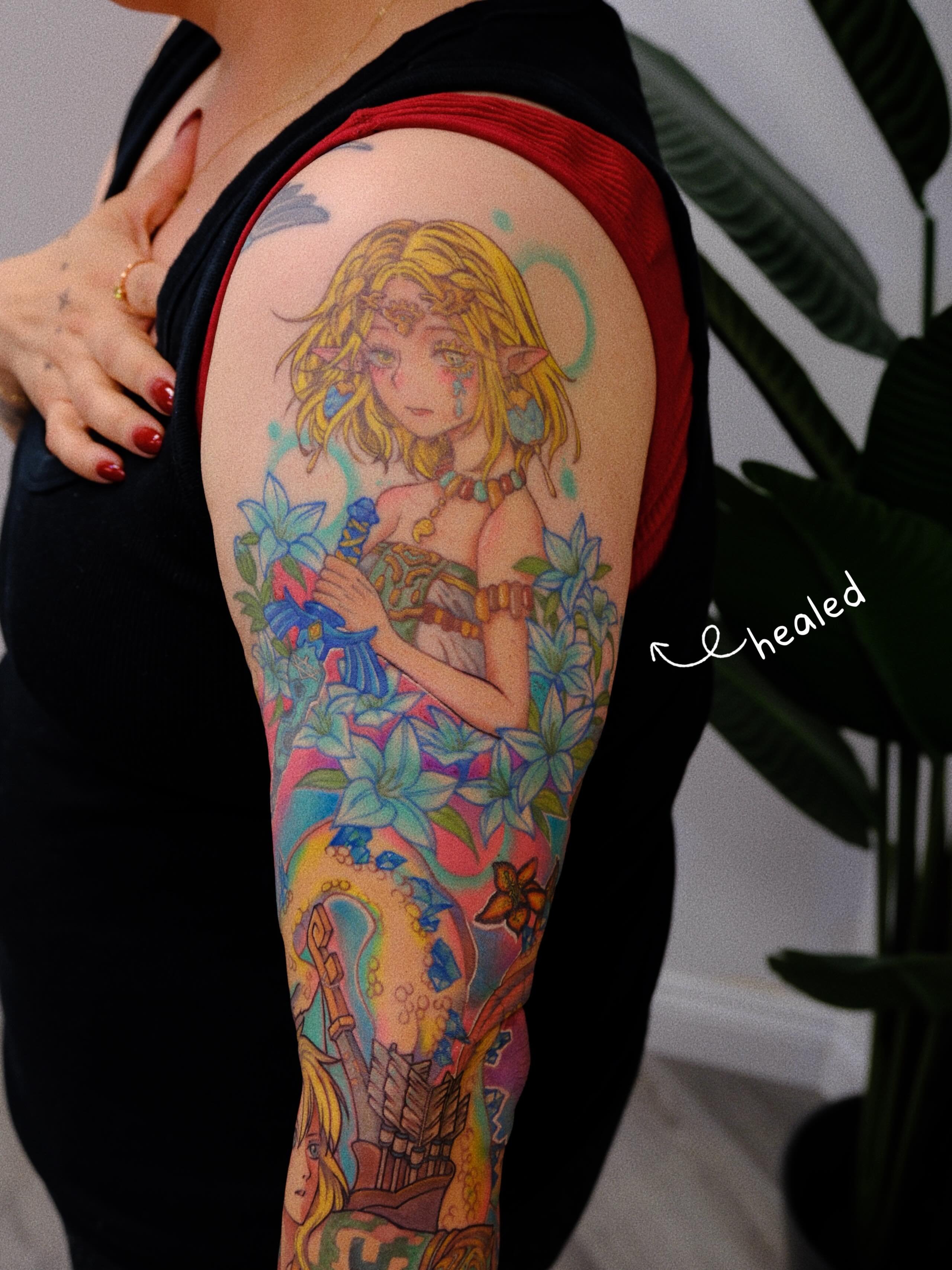 Elf girl with flowers new school tattoo on the upper arm by rita_tattooist