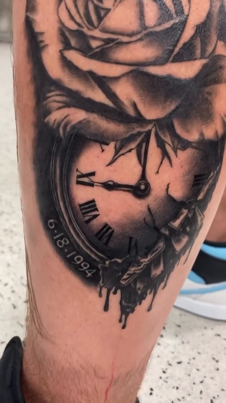Rose and clock with dripping effect surrealism tattoo on the calf by Timothy Murtaugh