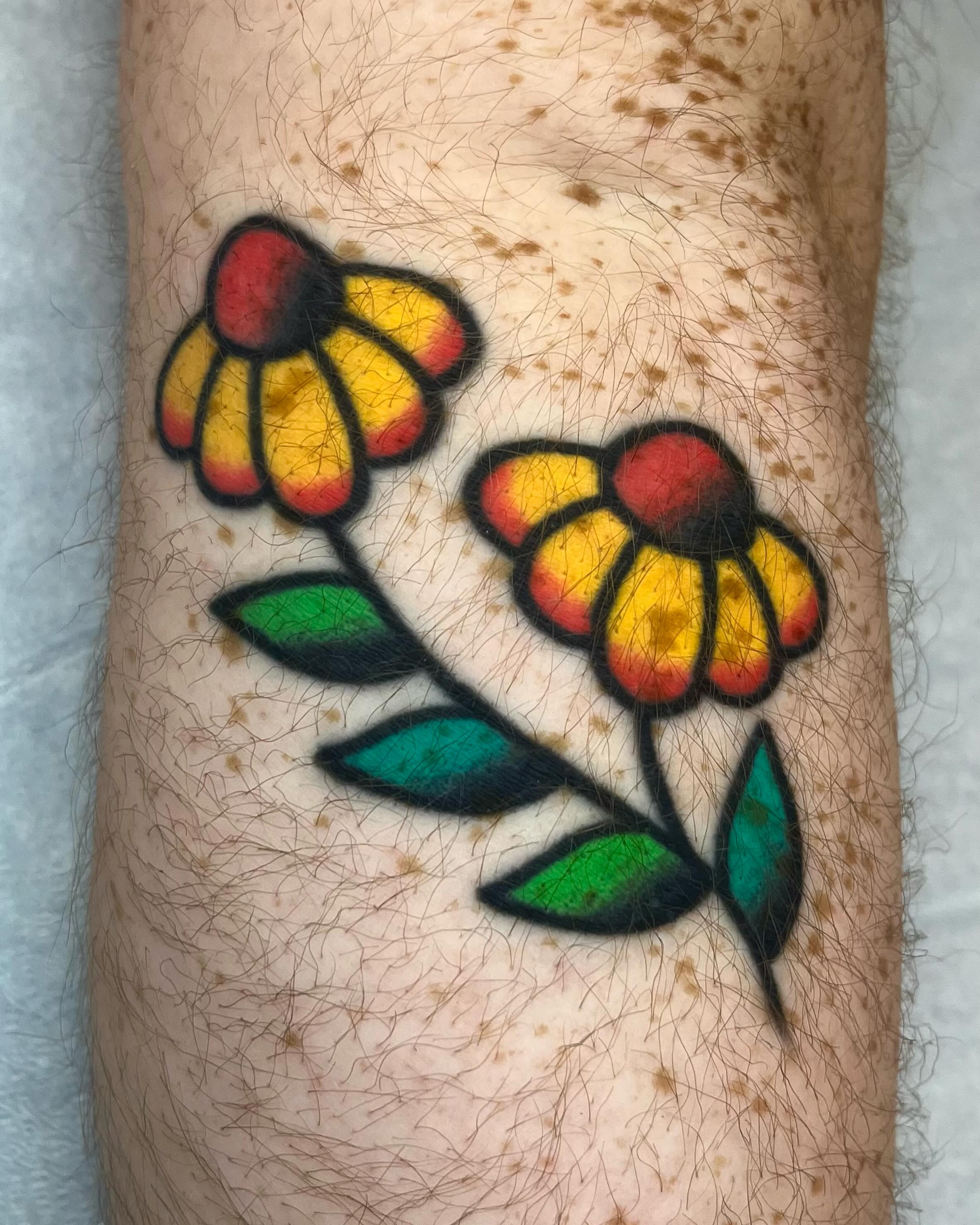 Flowers American traditional tattoo on the forearm by Em Adkins