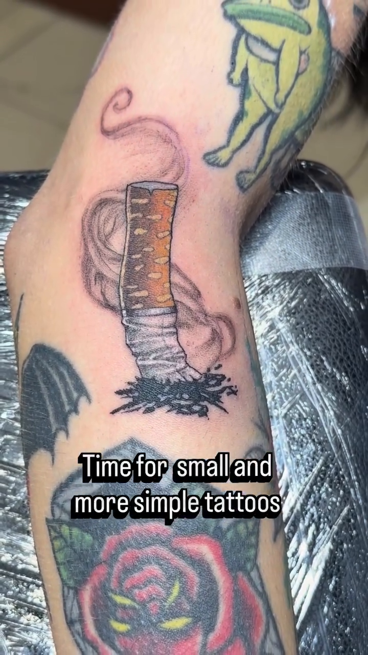 Cigarette with smoke and a frog minimalist tattoo on the forearm by Rafael Marte, White Plains, New York
