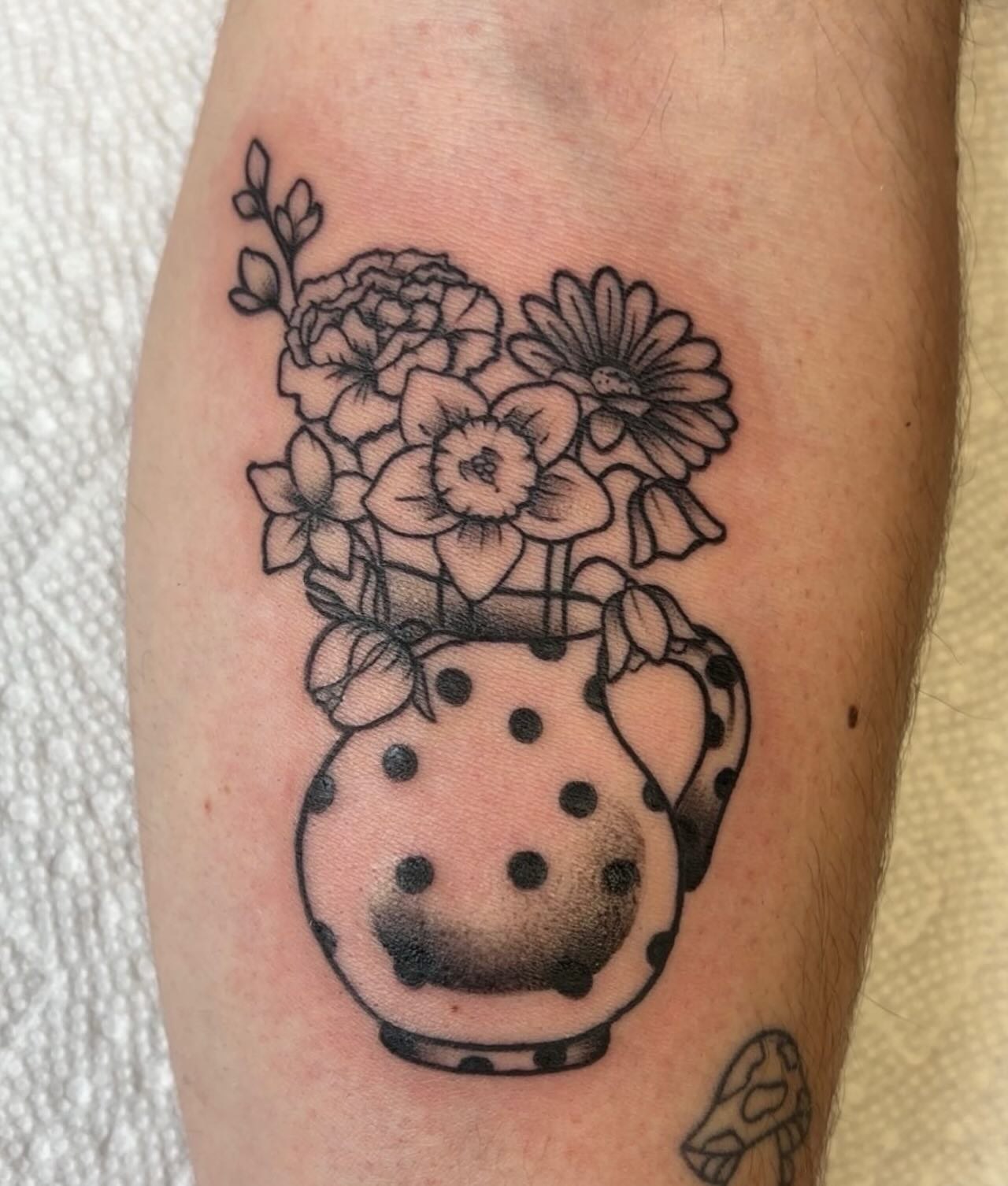 Polka dot vase with flowers dotwork tattoo on the forearm by Molly Dixon