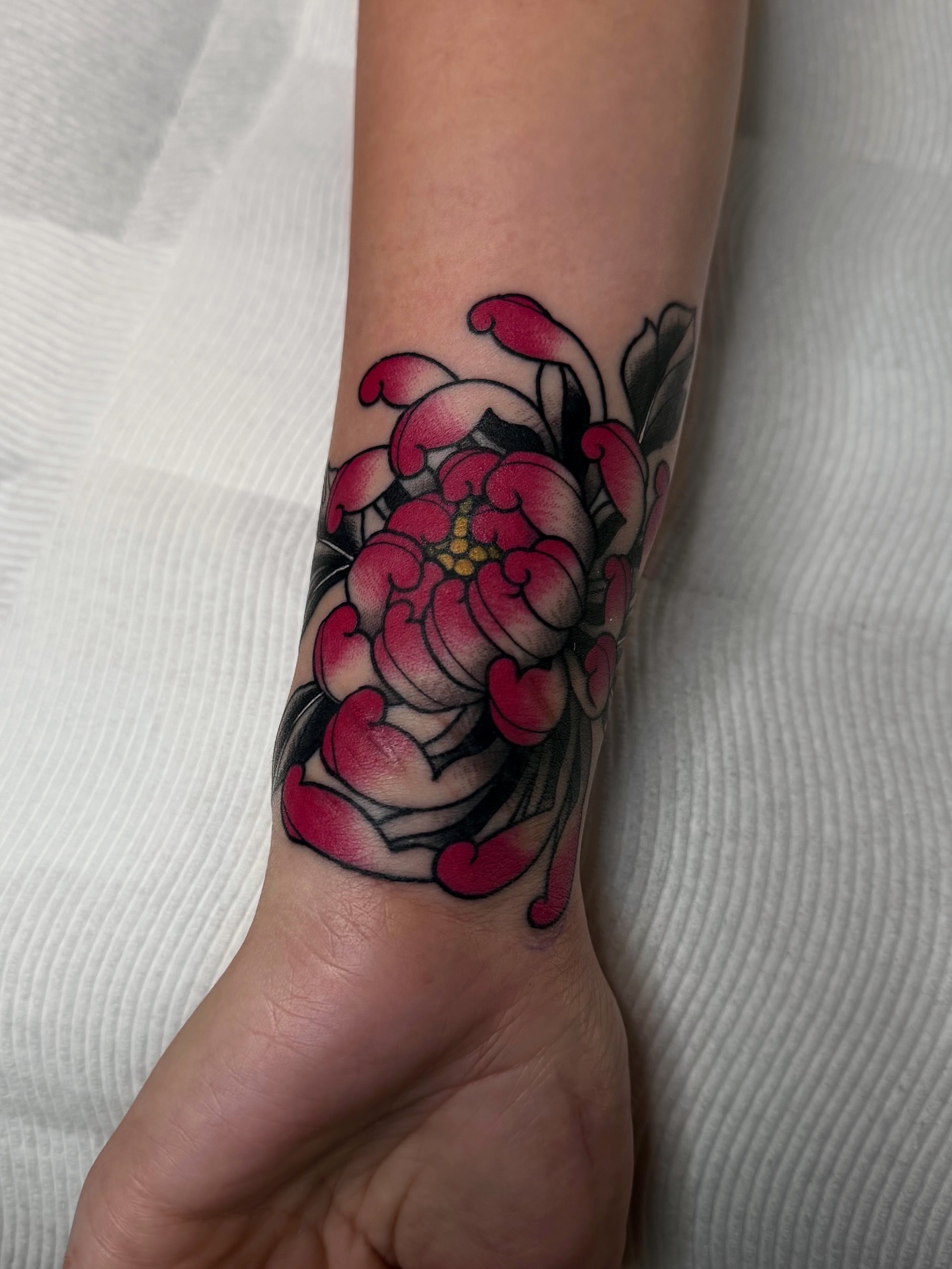 Peony American traditional tattoo on the forearm by Sacramento Tattoos (Ilona)