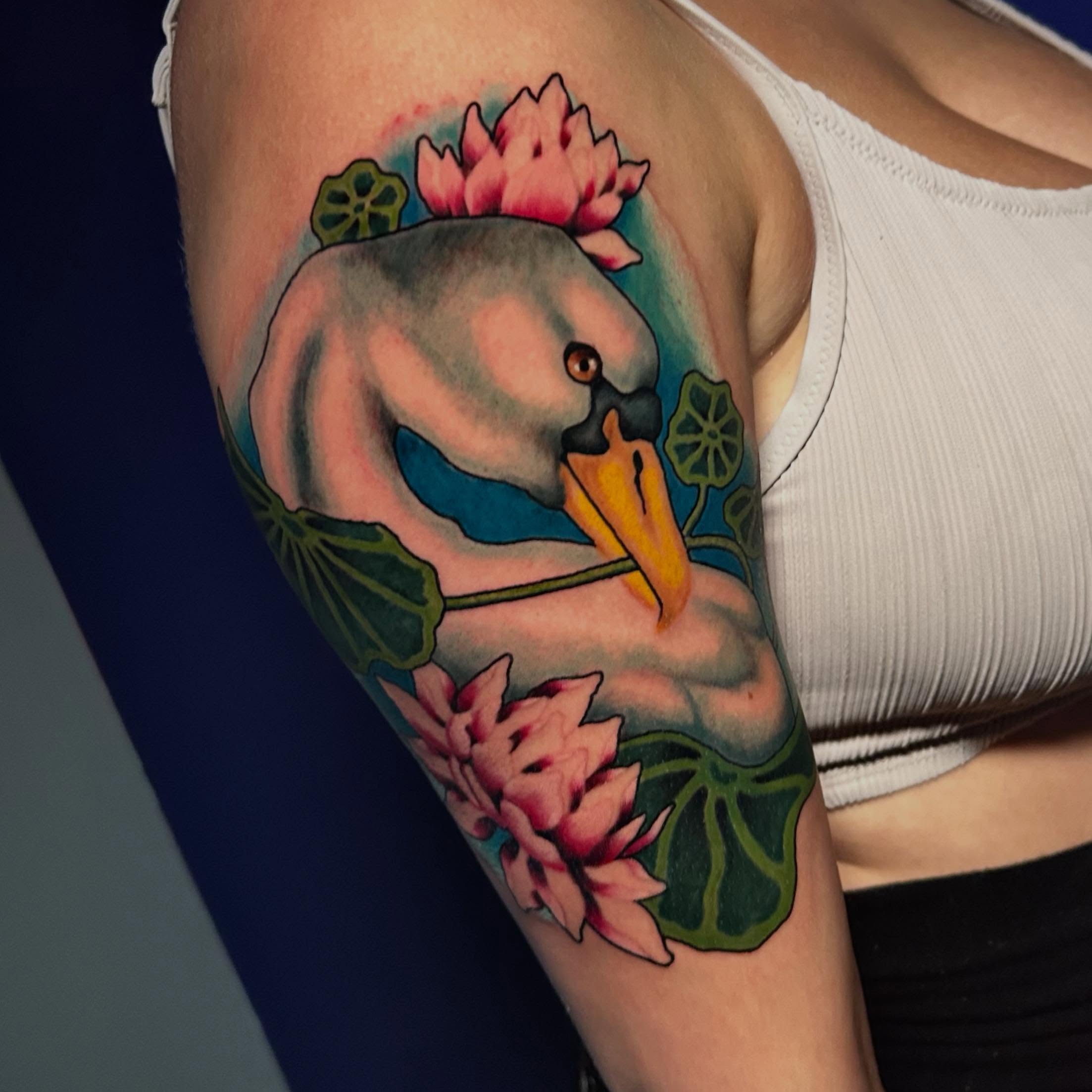 Swan and lotus flowers realism tattoo on the forearm by Adrian Michigan Tattoo Artist
