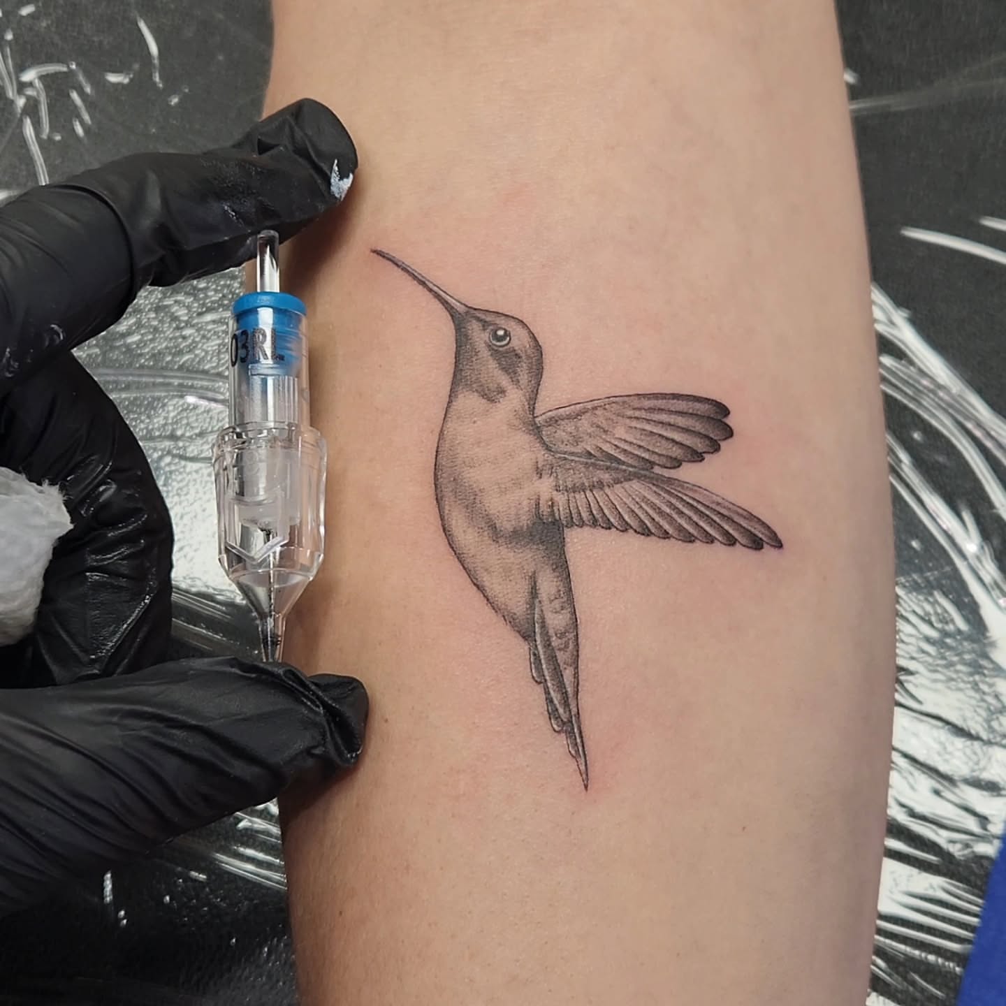 Hummingbird realism tattoo on the forearm by Jason August