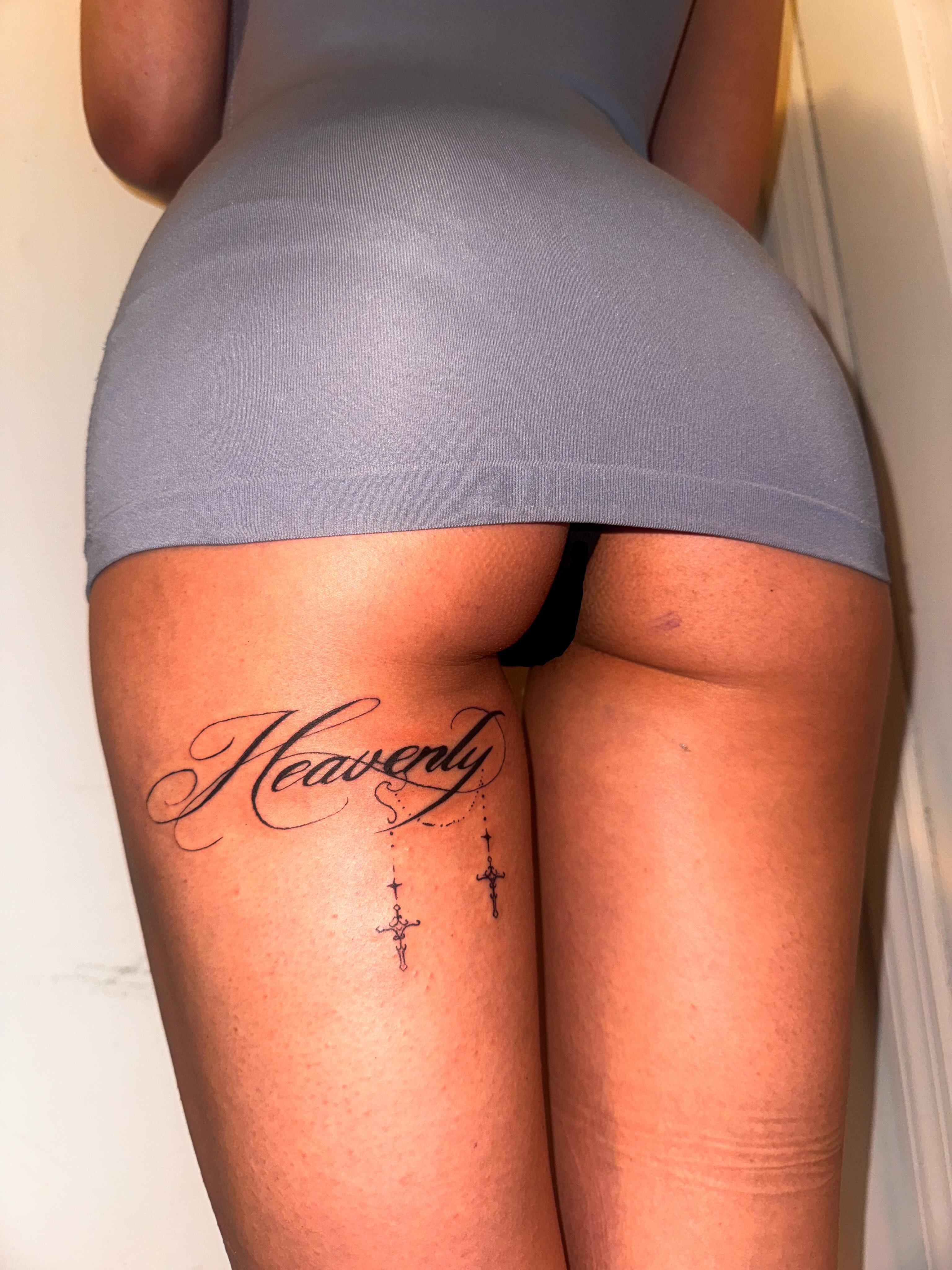 Heavenly lettering script tattoo on the thigh by Comet