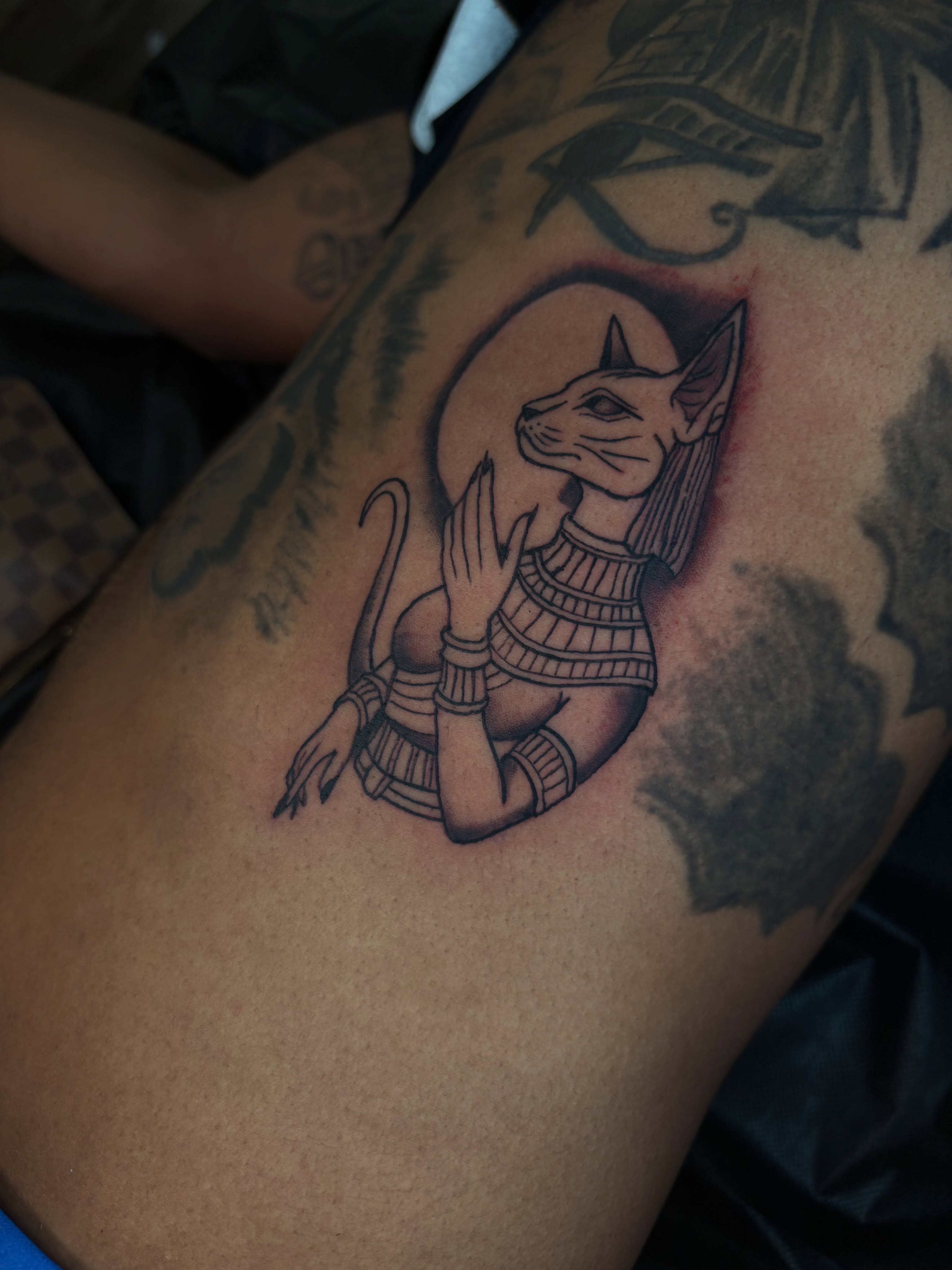 Cat goddess black and grey tattoo on the thigh by Mariyah Rhae Lewis