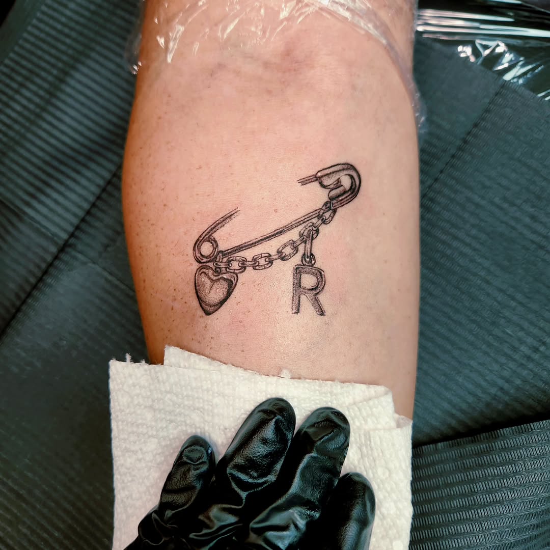 Minimalist tattoo on the forearm by Sarah Jones